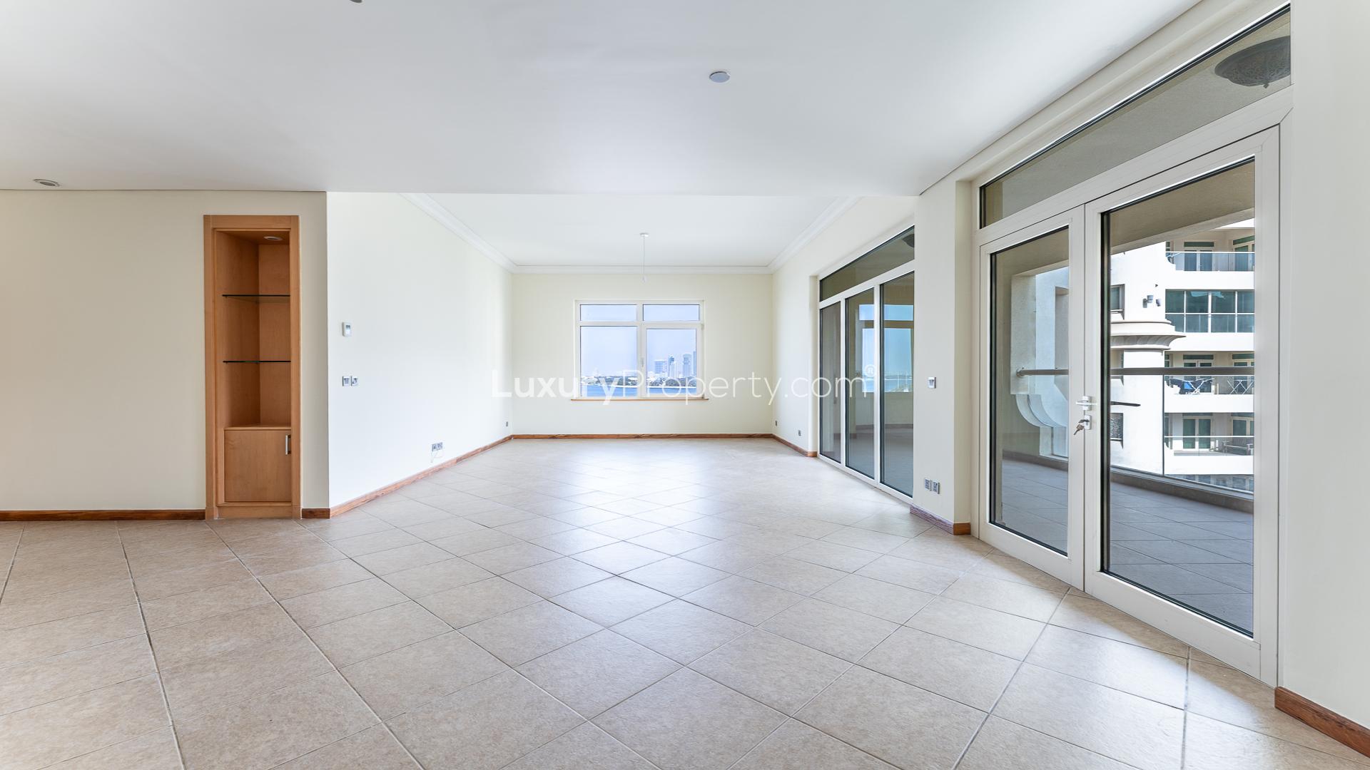 Spacious living area with large windows in Palm Jumeirah Shoreline Apartments, available for rent