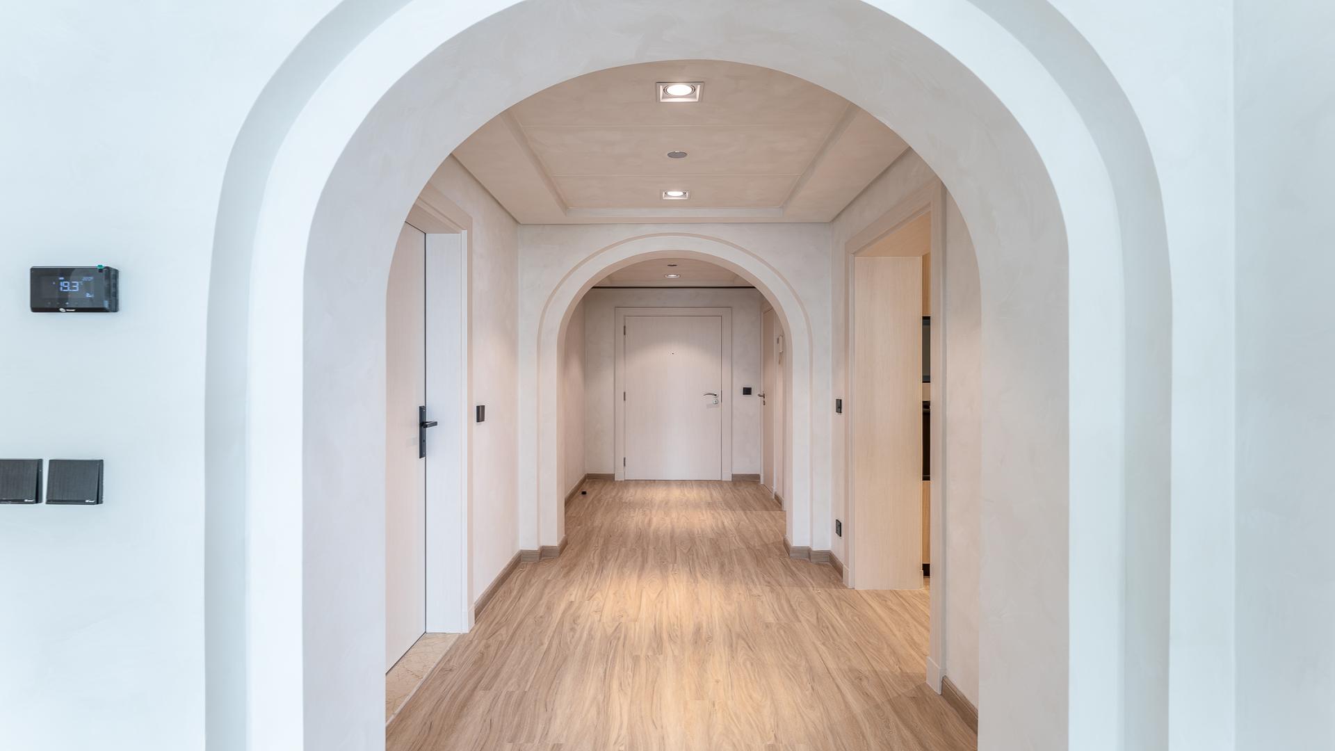 "Spacious hallway with arches in upgraded Shoreline Apartments, Palm Jumeirah, available for rent.",Vacant upgraded apartment interior with sea view, Shoreline Apartments, Palm Jumeirah, for rent