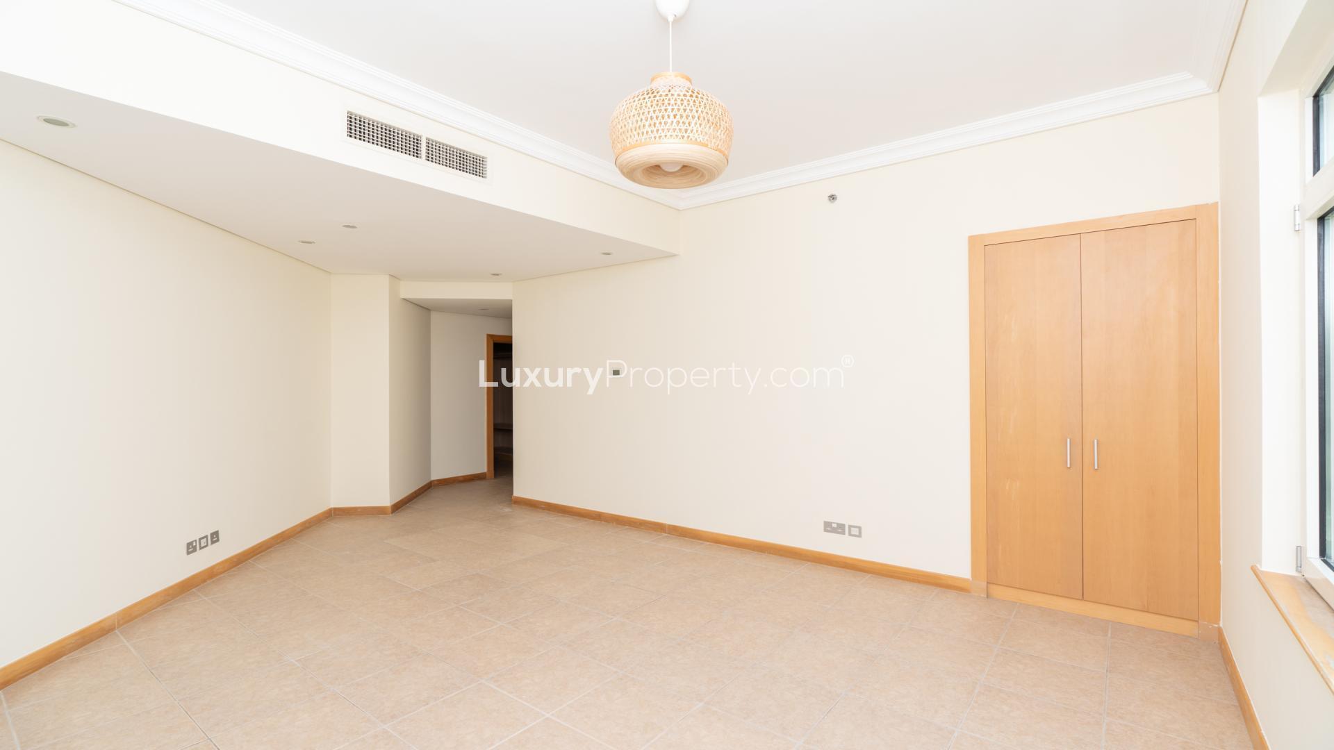 Empty living room in 3-bedroom apartment, Al Sultana, Palm Jumeirah, with large windows