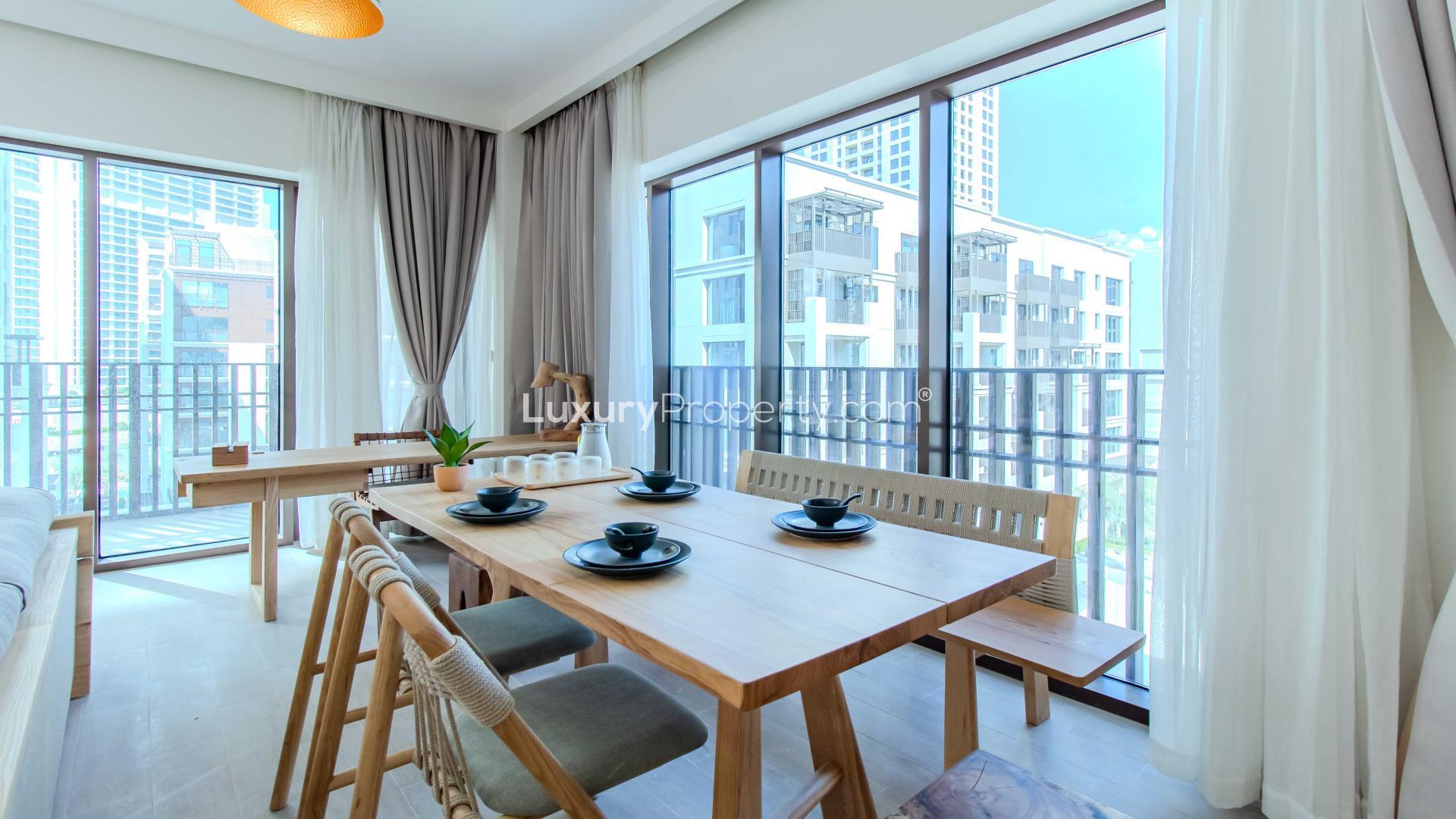 Apartment buildings at Creek Beach, Dubai Creek Harbour, with landscaped walkway and greenery