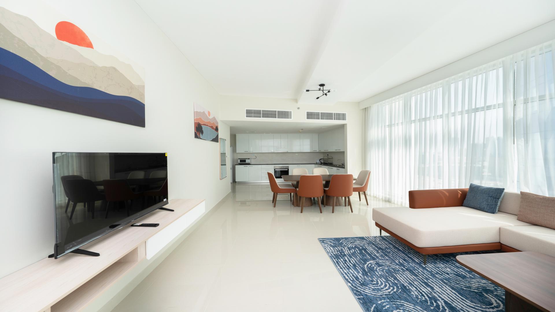 Modern living room in Al Sufouh apartment with stylish furniture and natural light