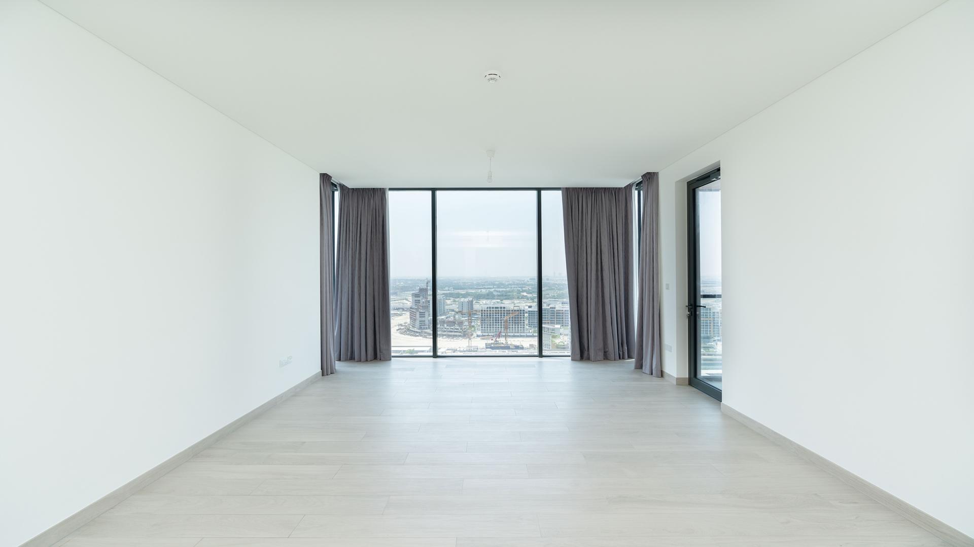 Modern living room with large windows in One Park Avenue apartment, Sobha Hartland