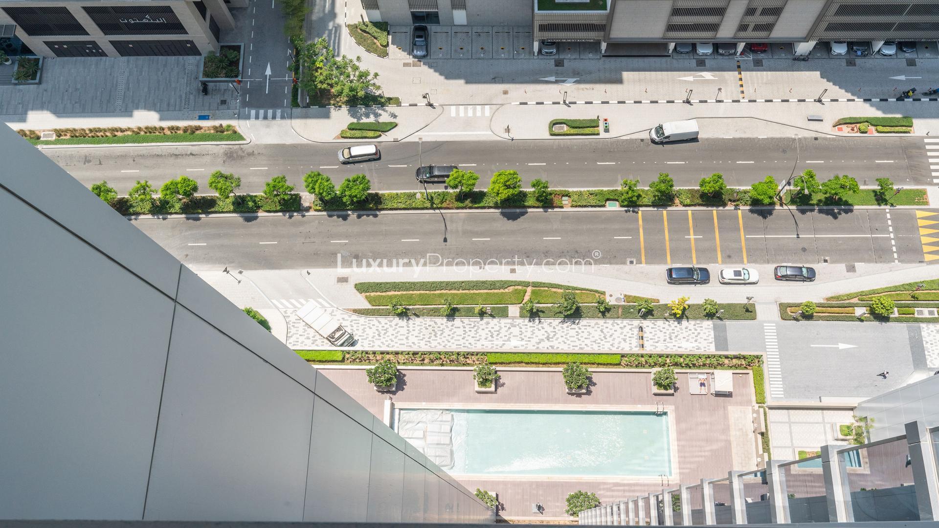 Aerial view of One Park Avenue apartment pool and street in Sobha Hartland