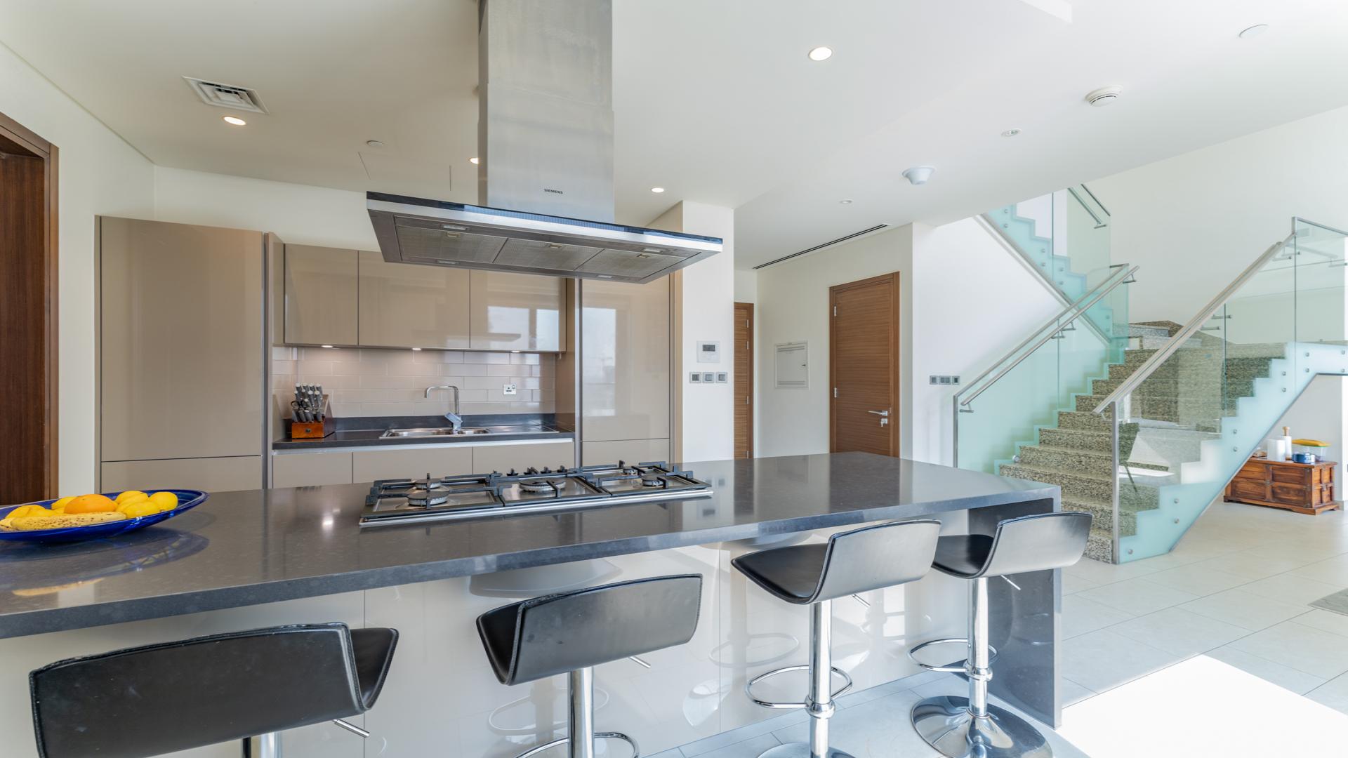 Bright living room in 3-bedroom duplex, Sobha Hartland, featuring modern decor and ample natural light