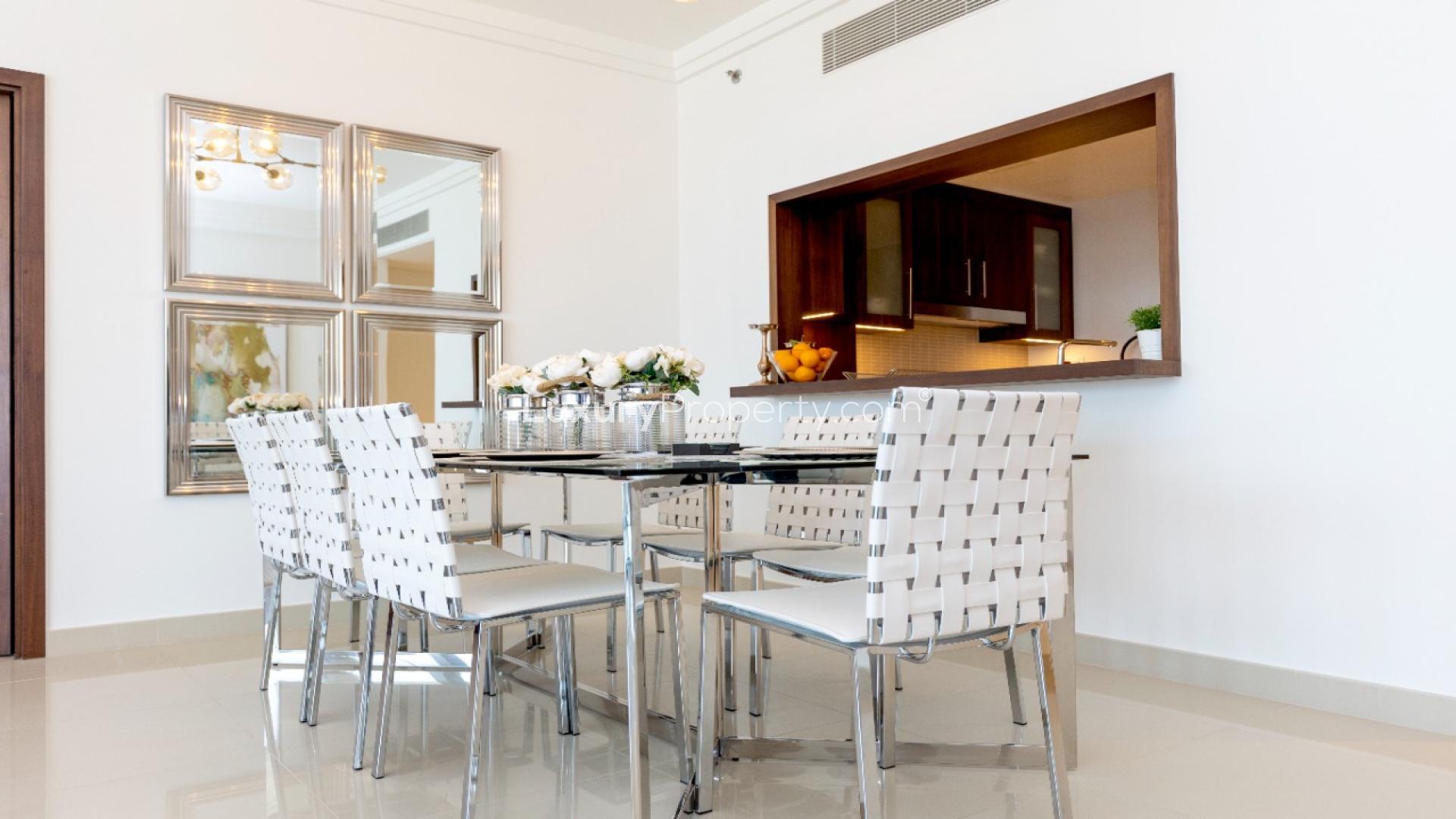 Modern living room in Boulevard Point apartment, Downtown Dubai with elegant red seating and decor