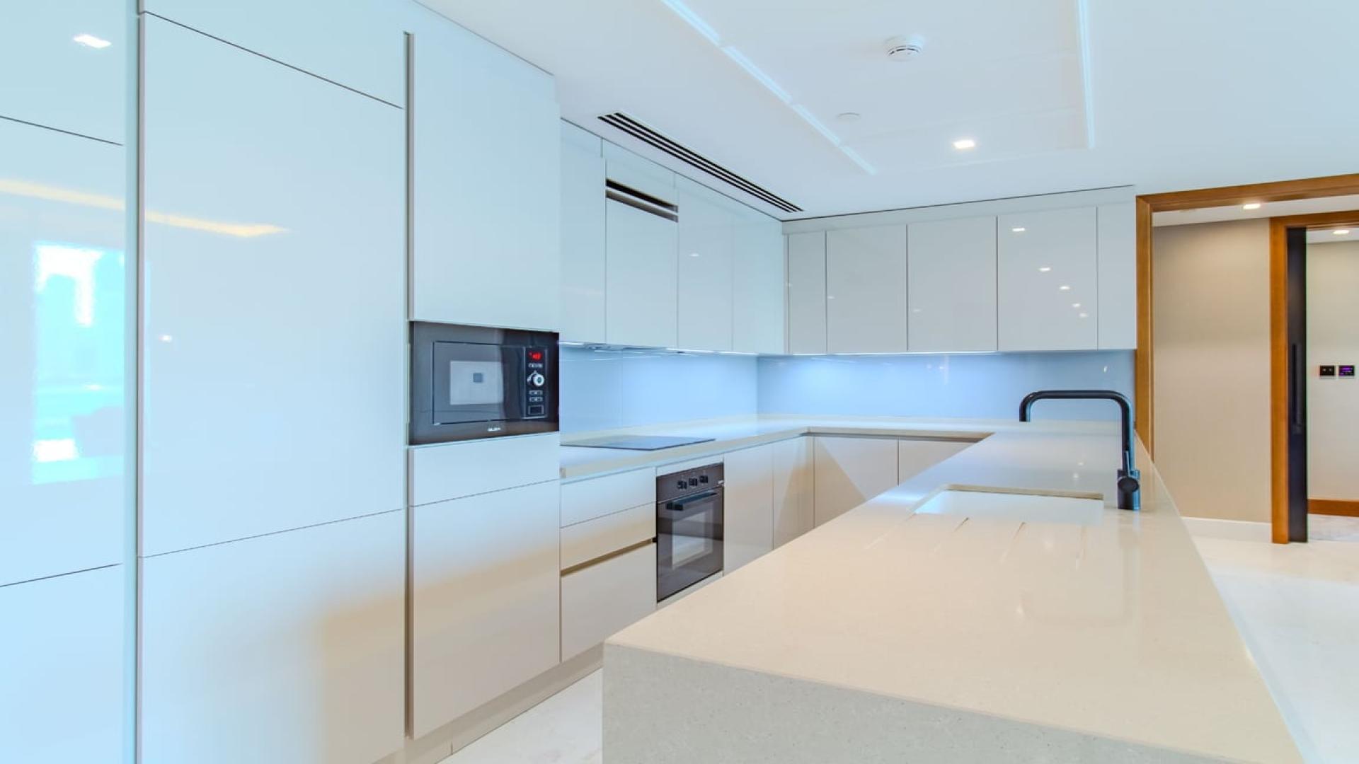 Modern kitchen in Bluewaters apartment, featuring sleek design and high-end appliances