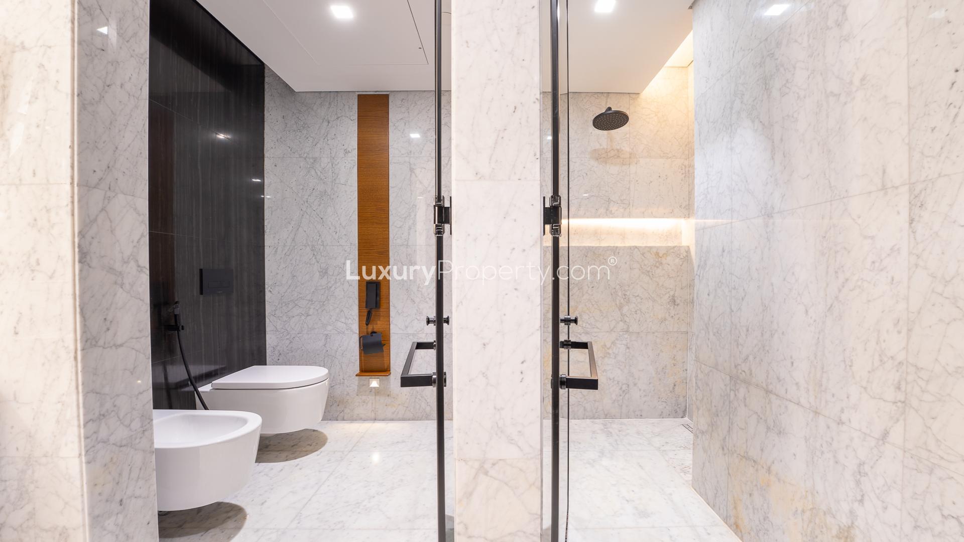 Modern kitchen and living area in Caesars Bluewaters Dubai apartment for rent