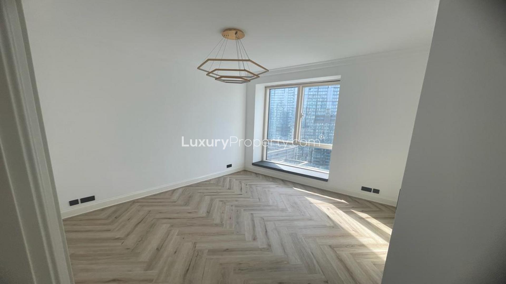 "Stunning view of Dubai Marina from Emaar 6 Towers, showcasing luxury waterfront apartments.",Bright bedroom with large window in Emaar 6 Towers, Dubai Marina apartment for rent