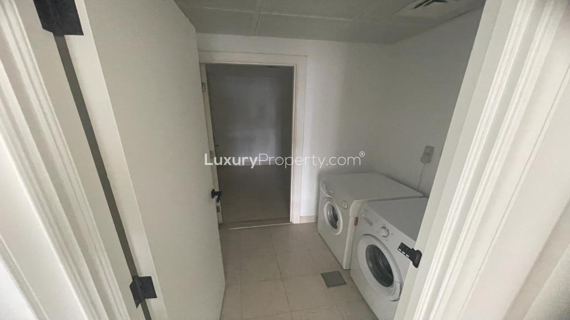 Laundry room with washer and dryer in Dubai Marina apartment, Emaar 6 Towers