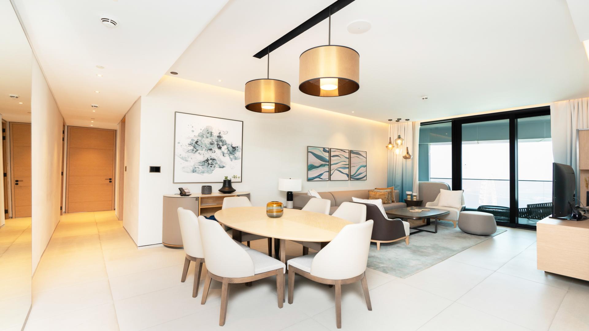 Balcony view from 3-bedroom apartment in Jumeirah Gate Tower 2, overlooking sea and cityscape