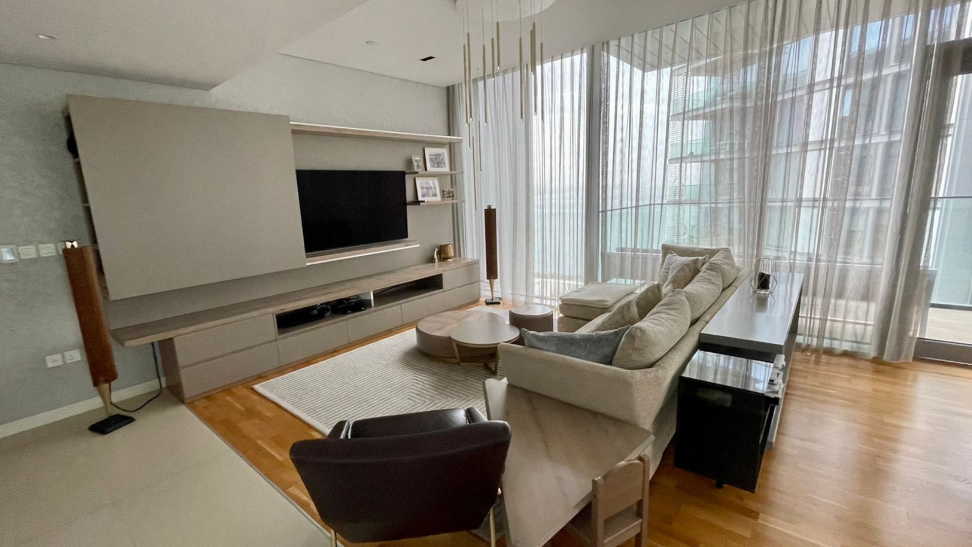 Balcony view of waterfront apartment at Bluewaters Residence, featuring modern outdoor seating