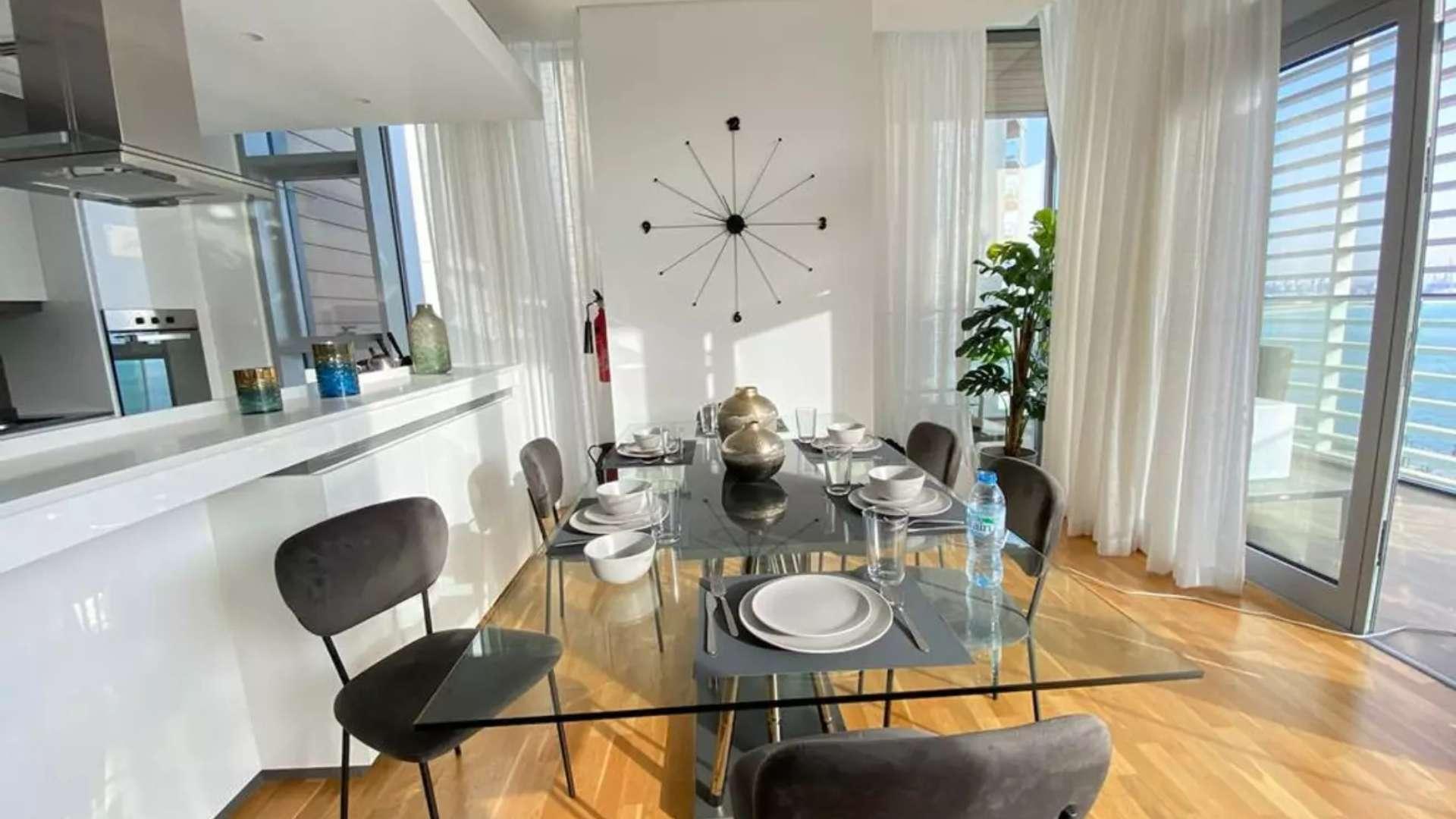 Furnished Bluewaters apartment living area with modern kitchen and dining space