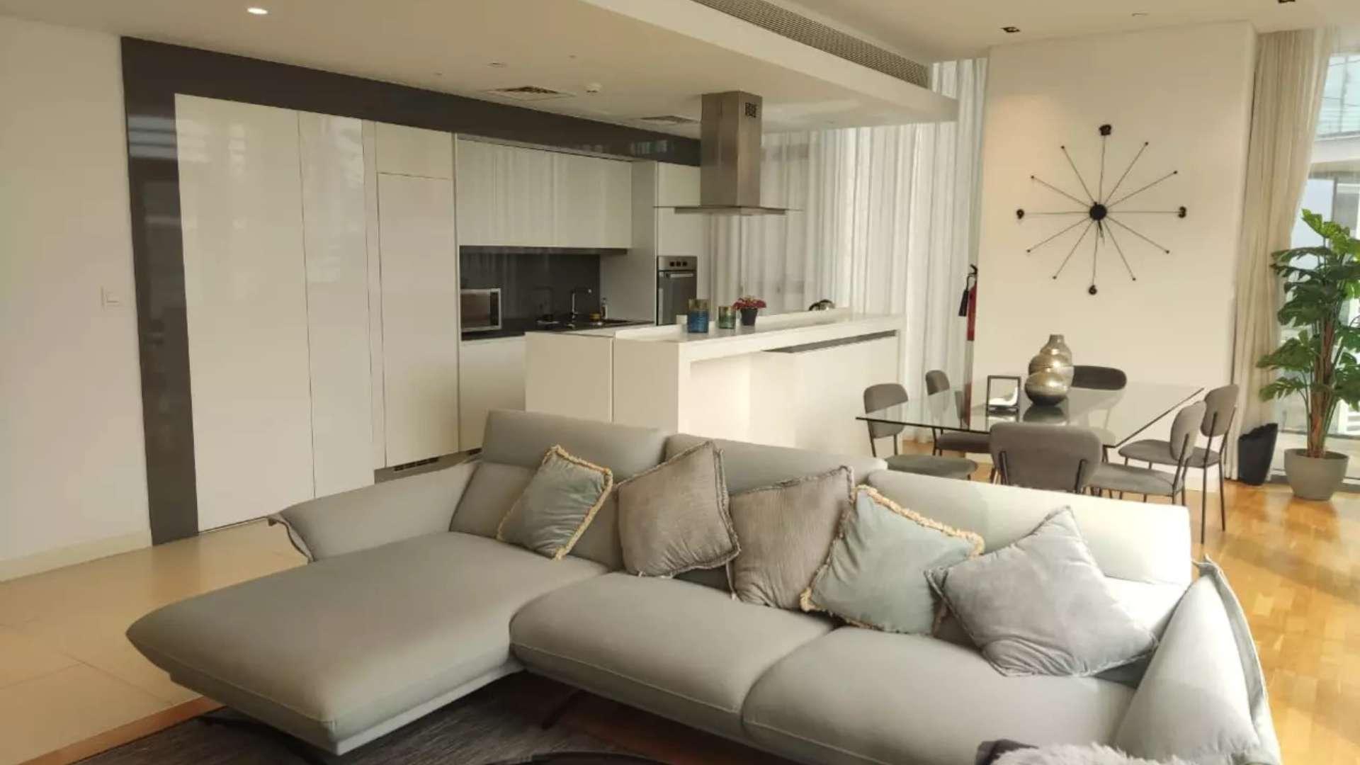 Furnished Bluewaters apartment living room with modern decor and partial sea view windows