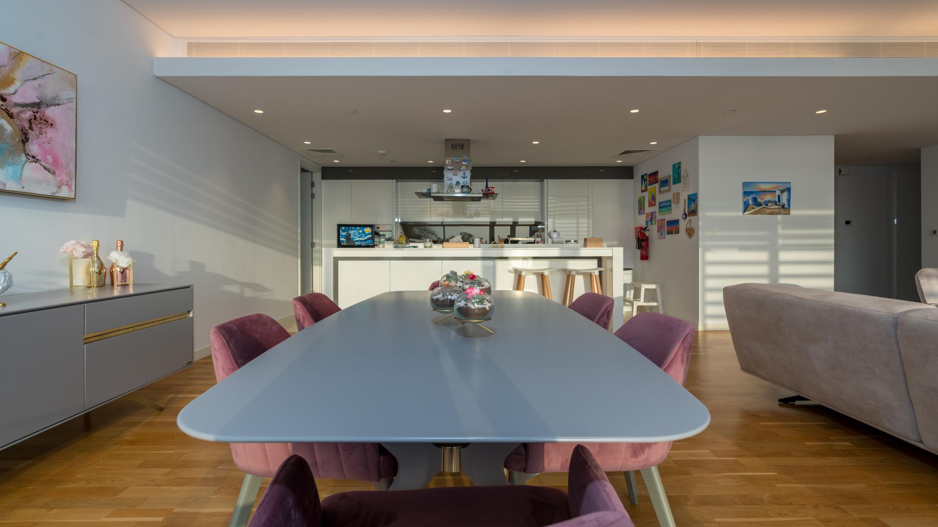 N/A,Furnished open-plan living and dining area in Bluewaters apartment, featuring modern kitchen and decor
