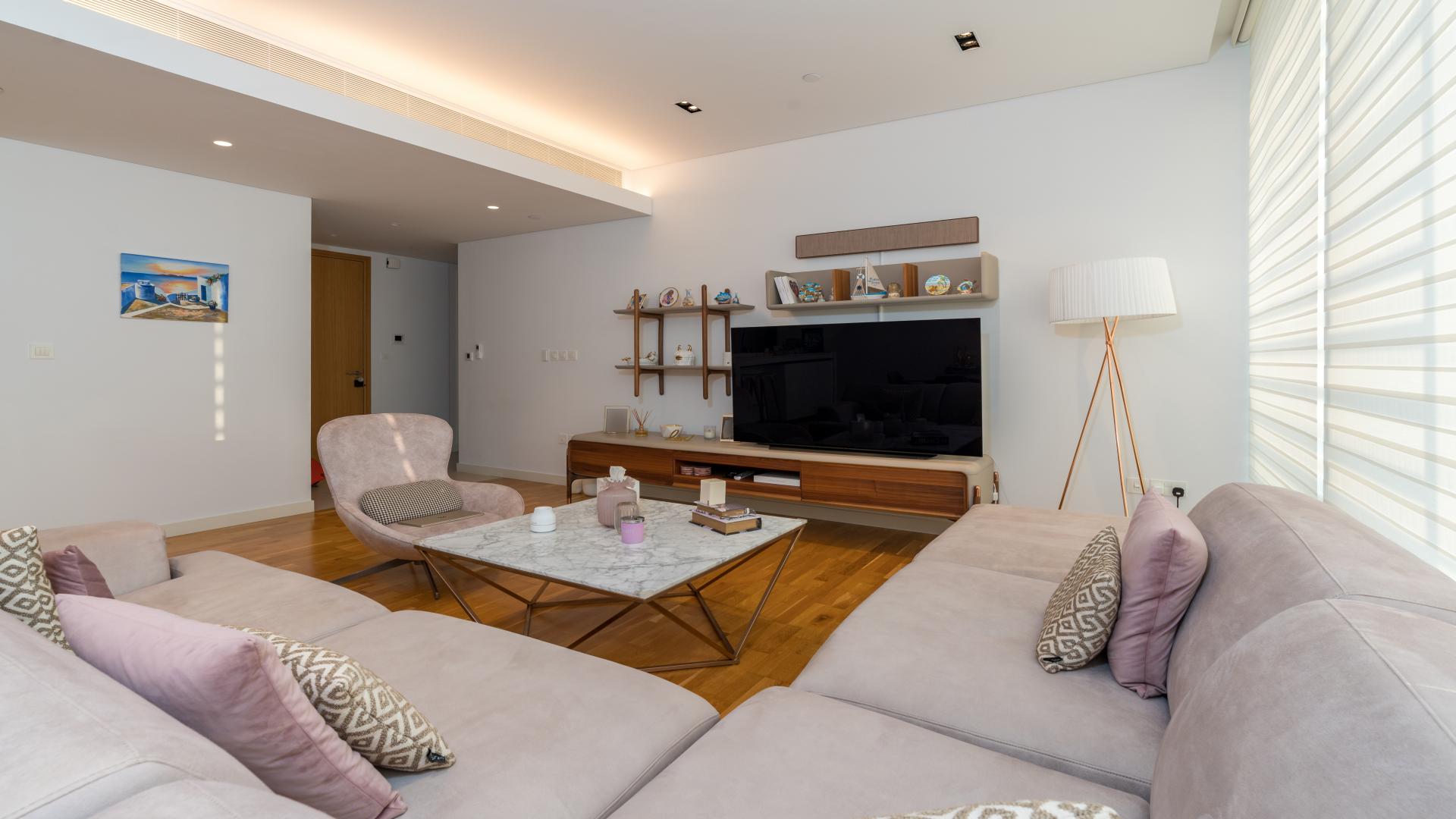 Furnished living room in Bluewaters Residences apartment with modern decor and natural light