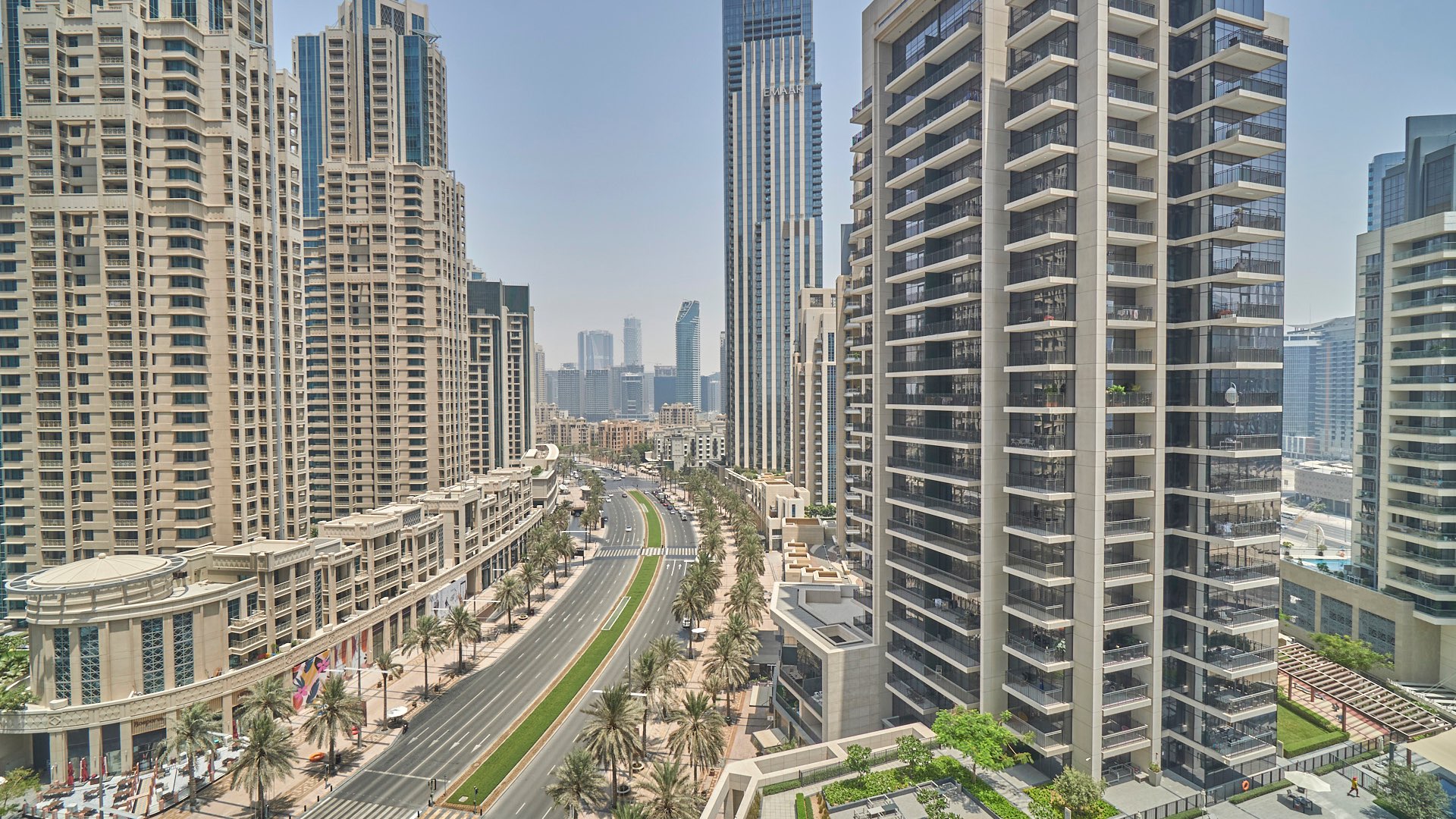 Aerial view of BLVD Crescent apartment complex with pool, Downtown Dubai skyline backdrop