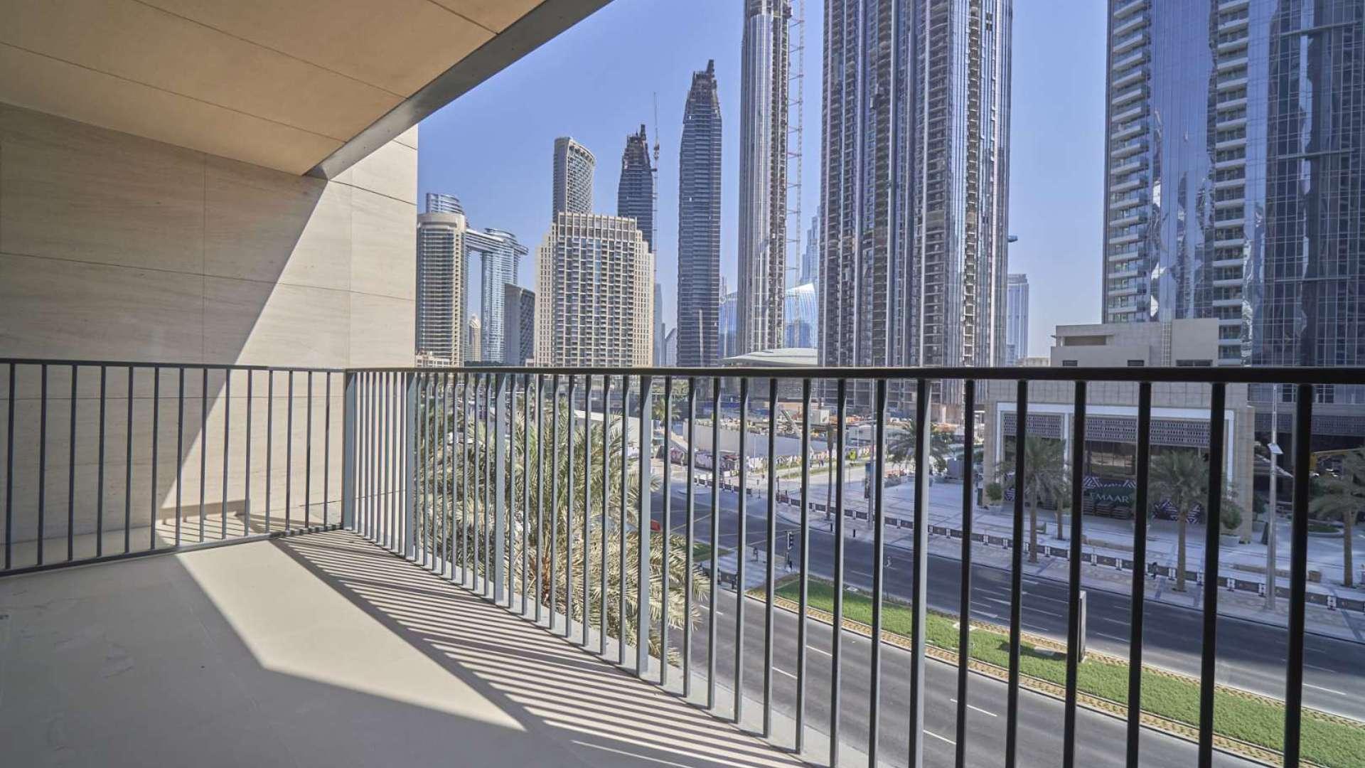 "Bright living room with large windows, stunning view in BLVD Heights, Downtown Dubai apartment.",Balcony view from duplex apartment in BLVD Heights, Downtown Dubai, overlooking skyscrapers