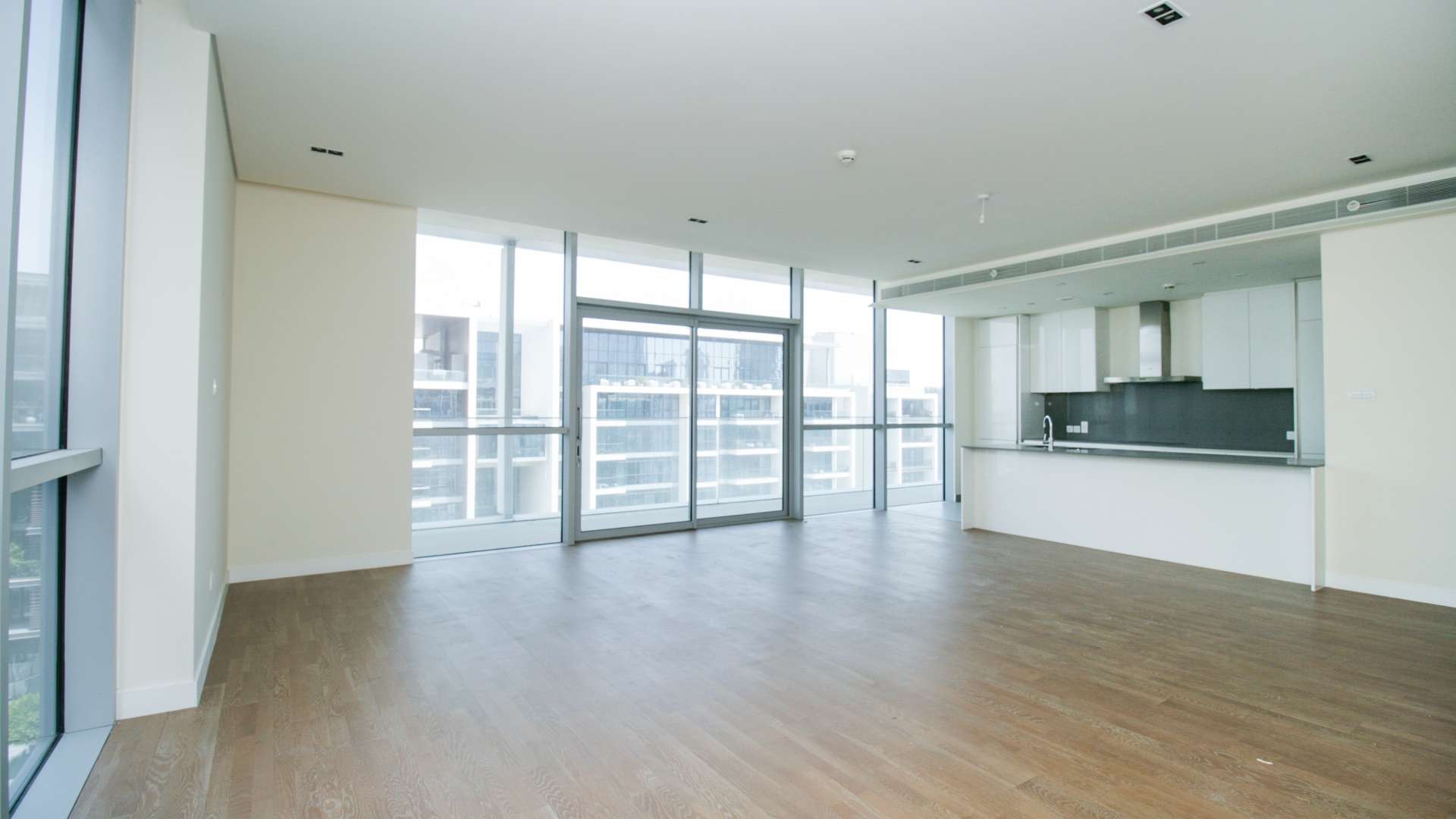 Modern open-plan kitchen and living area in City Walk apartment for rent
