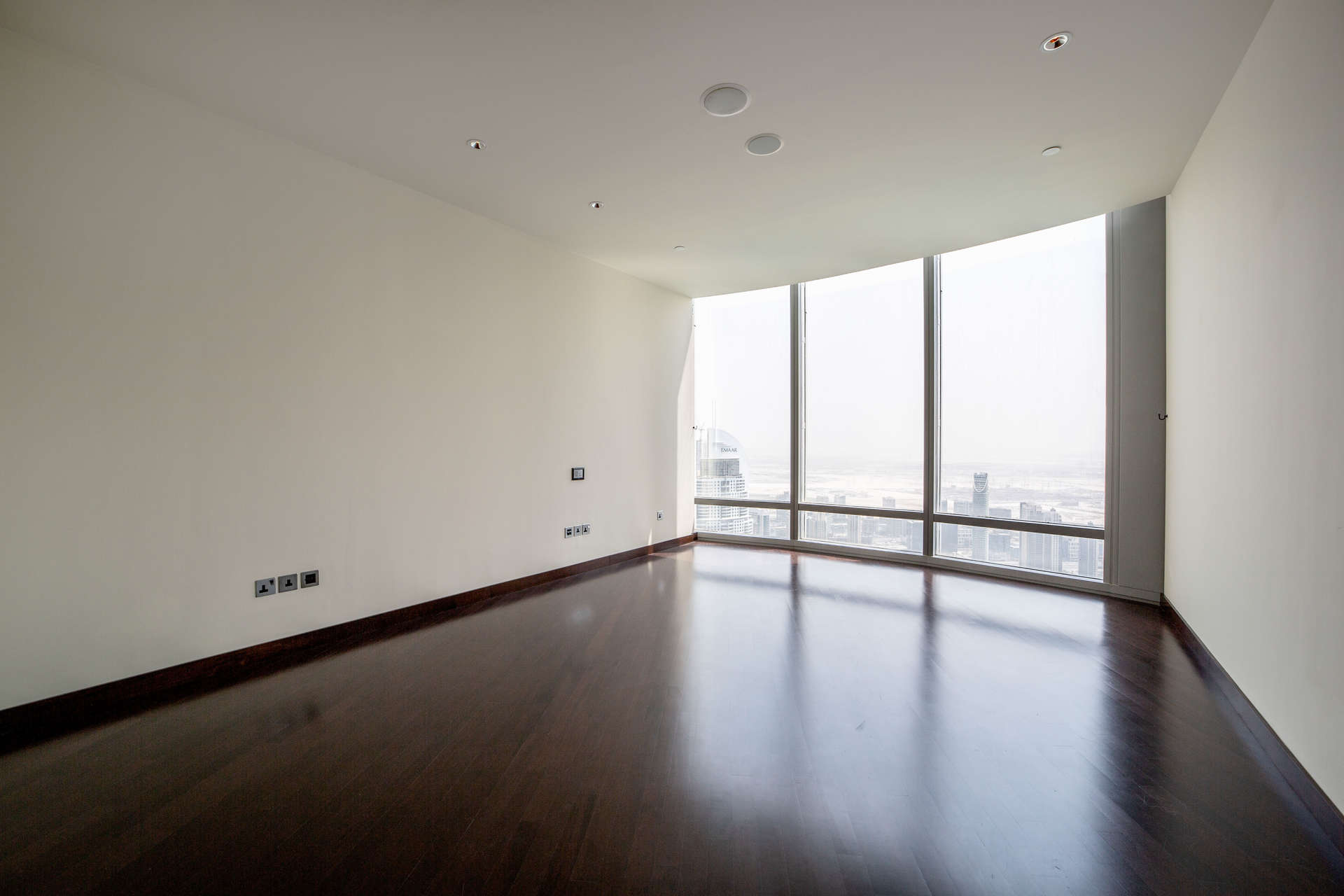 "Stunning view of Burj Khalifa and surrounding area in Downtown Dubai, near apartment listing.",Empty room with large windows in three-bedroom apartment, Burj Khalifa, Downtown Dubai
