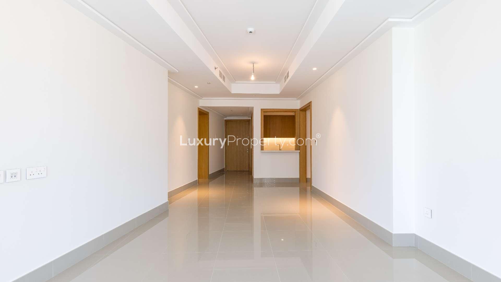Empty living room with large windows in Opera Grand apartment, Downtown Dubai