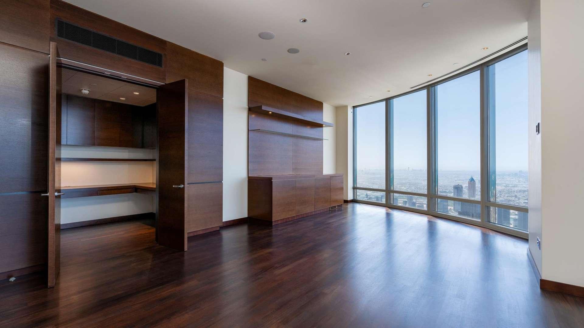 "Elegant living area with floor-to-ceiling windows in Burj Khalifa apartment, Downtown Dubai.",Spacious living area with floor-to-ceiling windows in Burj Khalifa apartment, Downtown Dubai