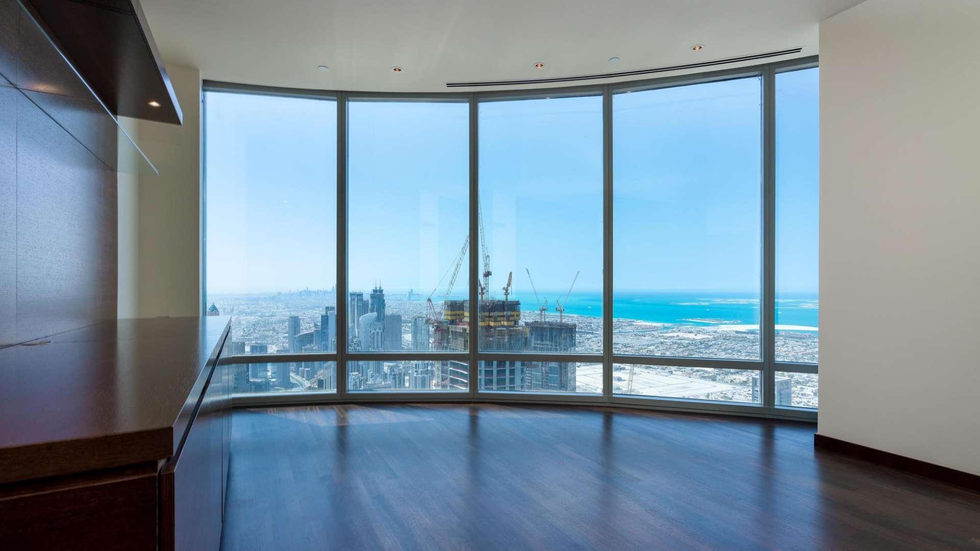 "Elegant living room with panoramic views in Burj Khalifa apartment, Downtown Dubai.",N/A,Spacious living area with floor-to-ceiling windows, iconic views, Burj Khalifa apartment
