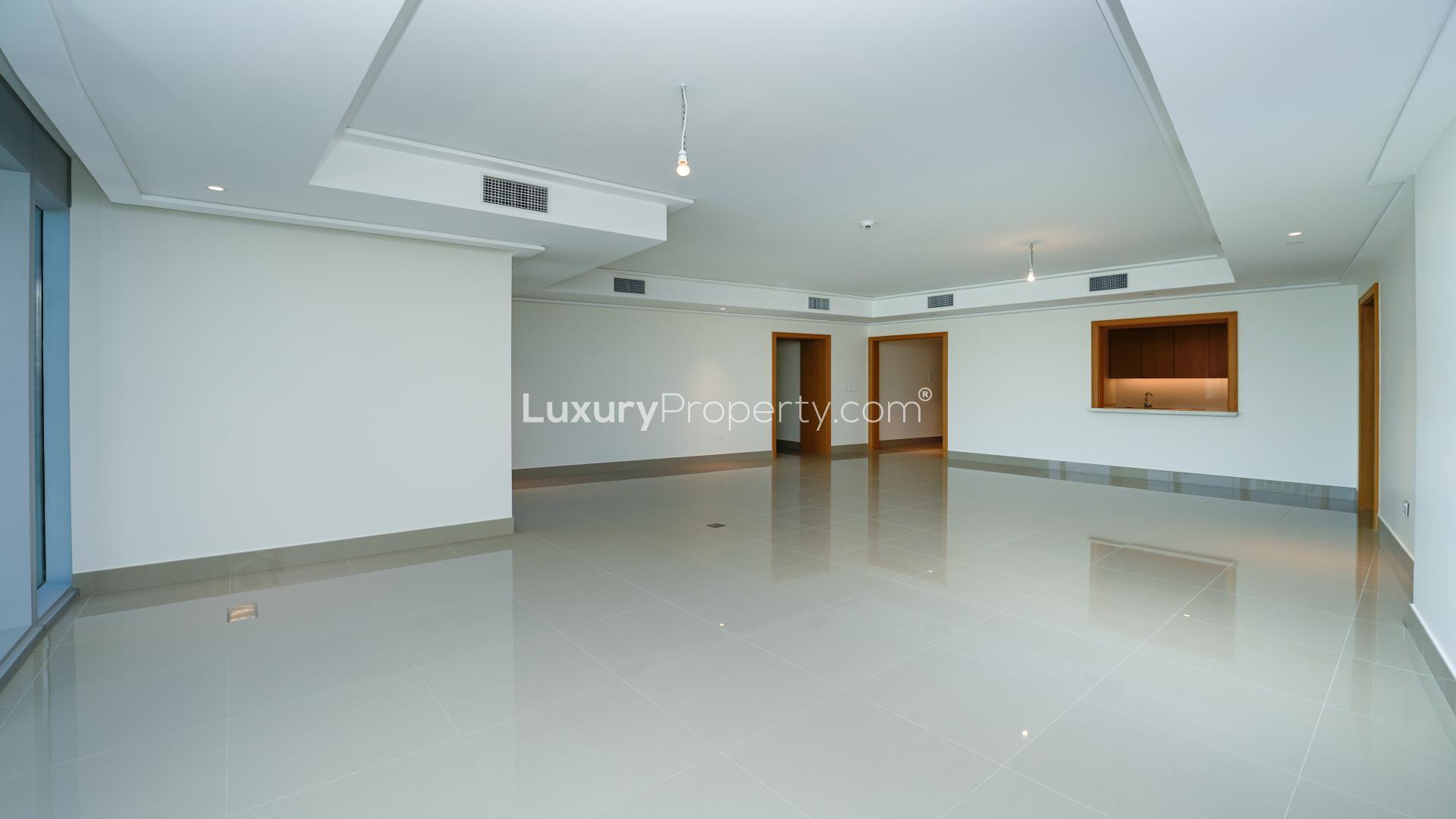 Empty room with large windows and Burj Khalifa views in Opera Grand Apartment, Downtown Dubai