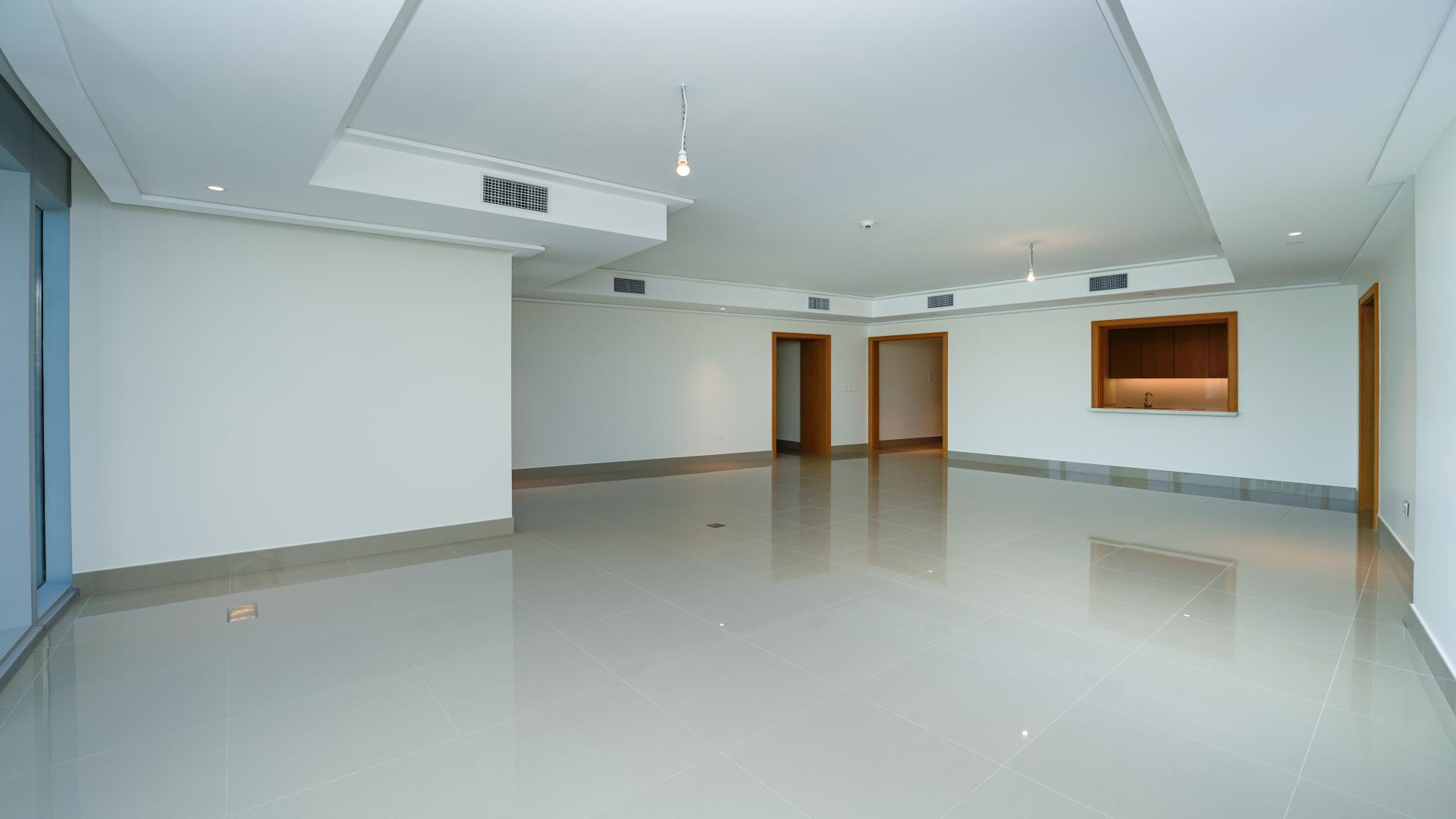 Empty room with large windows and Burj Khalifa views in Opera Grand Apartment, Downtown Dubai