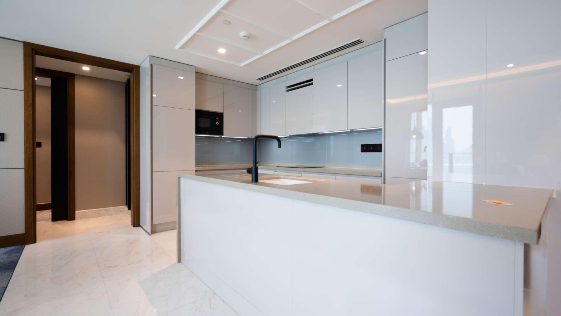 Modern living room in 3-bedroom Bluewaters apartment, open kitchen design, elegant furnishings