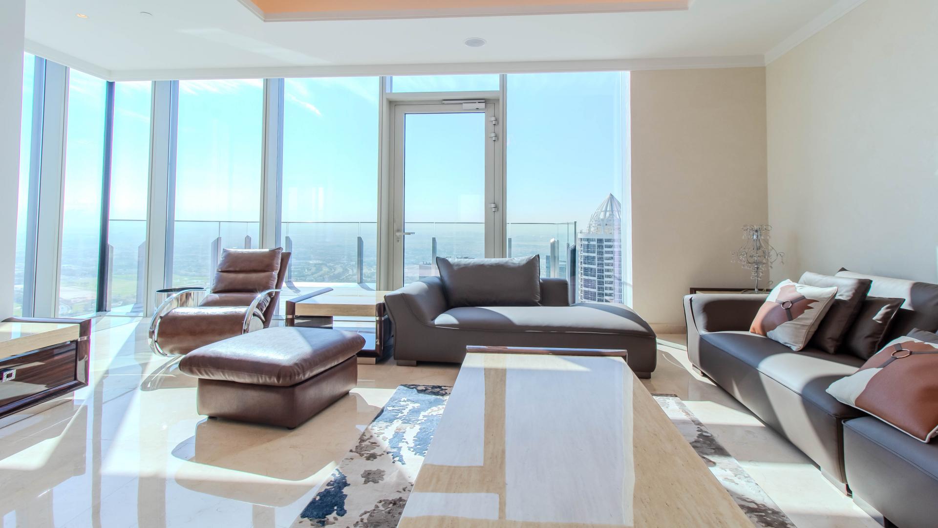Stylish living room in JLT apartment with modern furniture and panoramic golf course view