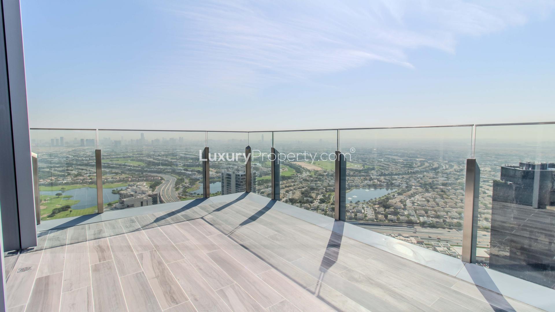 Stylish apartment living room with modern furniture and golf course view at JLT Residences