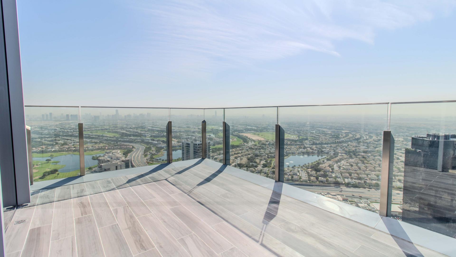 Stylish apartment living room with modern furniture and golf course view at JLT Residences