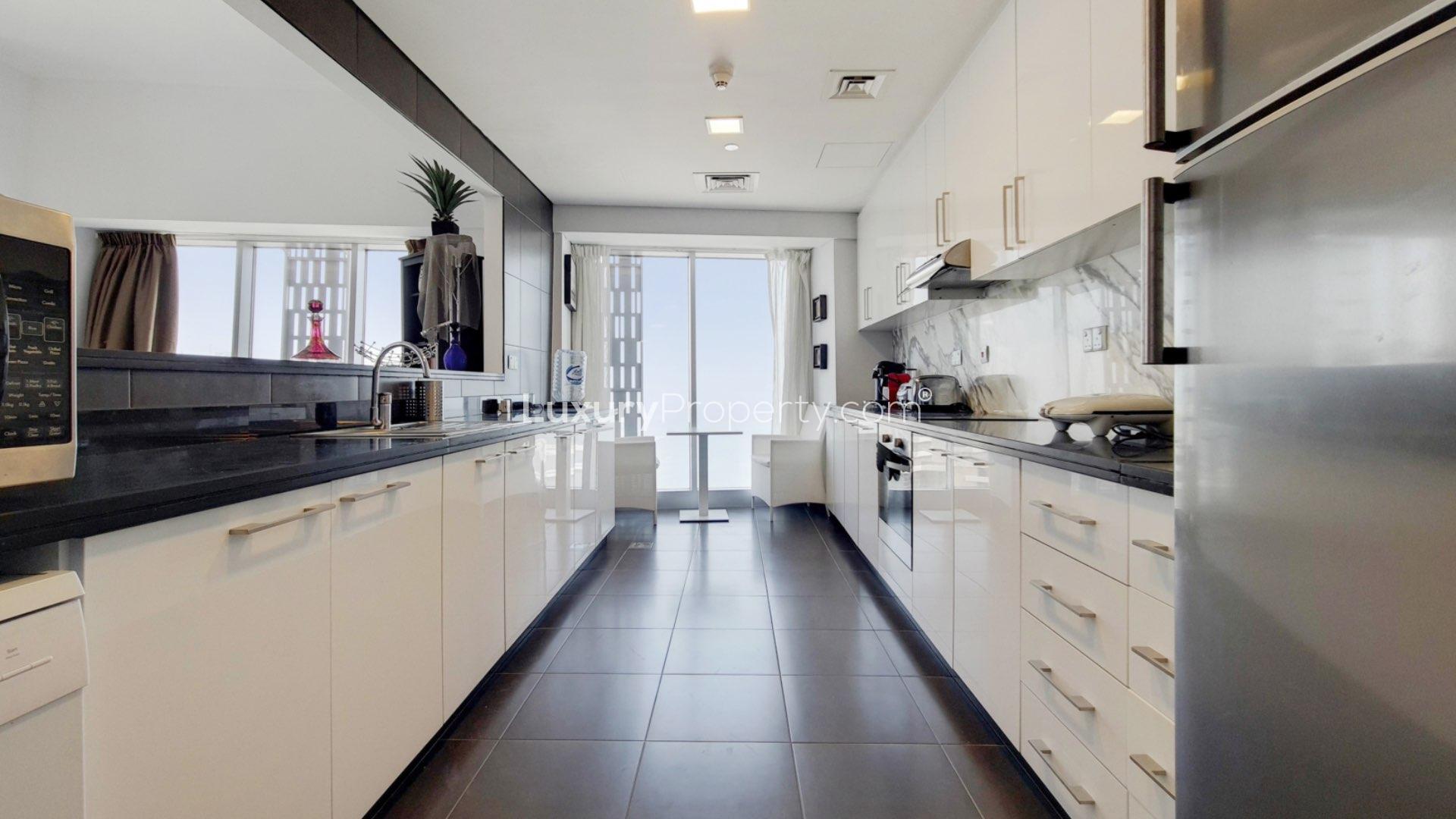 Luxury waterfront apartment dining and living area in Cayan Tower, Dubai Marina. Fully furnished