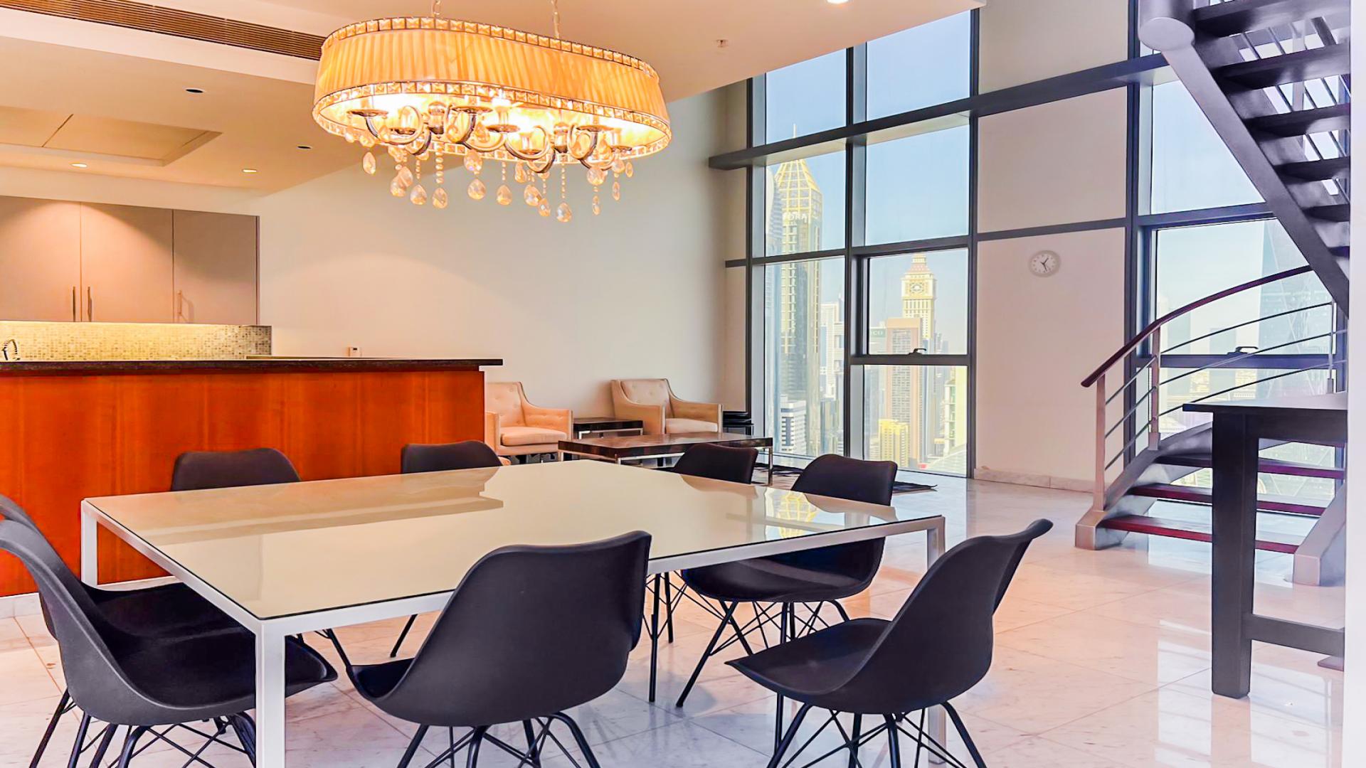 Luxury duplex interior with spiral staircase and chandelier in DIFC Central Park Tower apartment