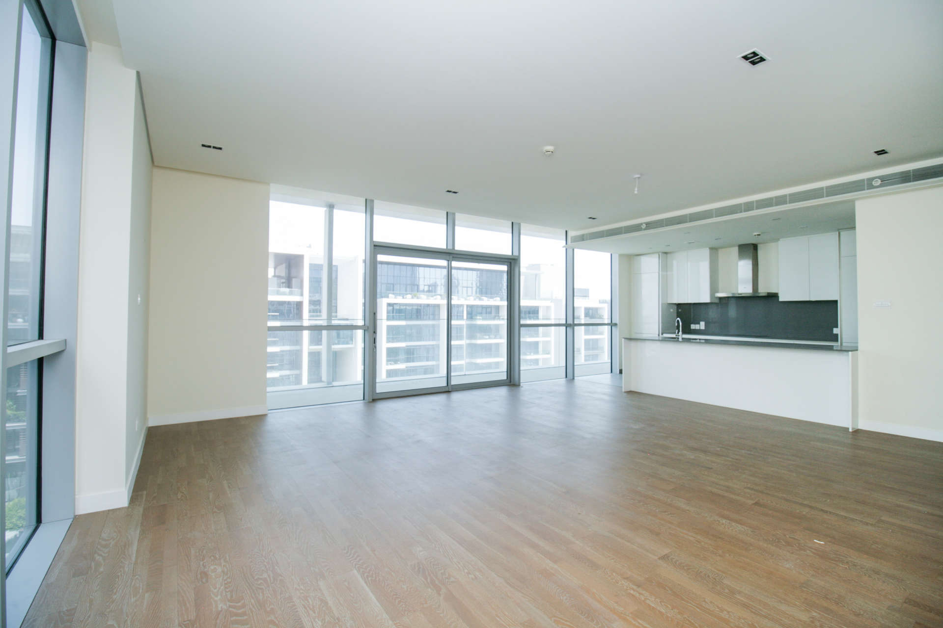 Empty room with tiled floor and large window in City Walk apartment, Dubai