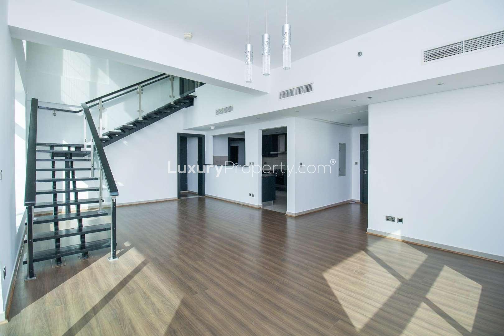 Aerial view of serene lake and lush greenery in Jumeirah Heights, Dubai