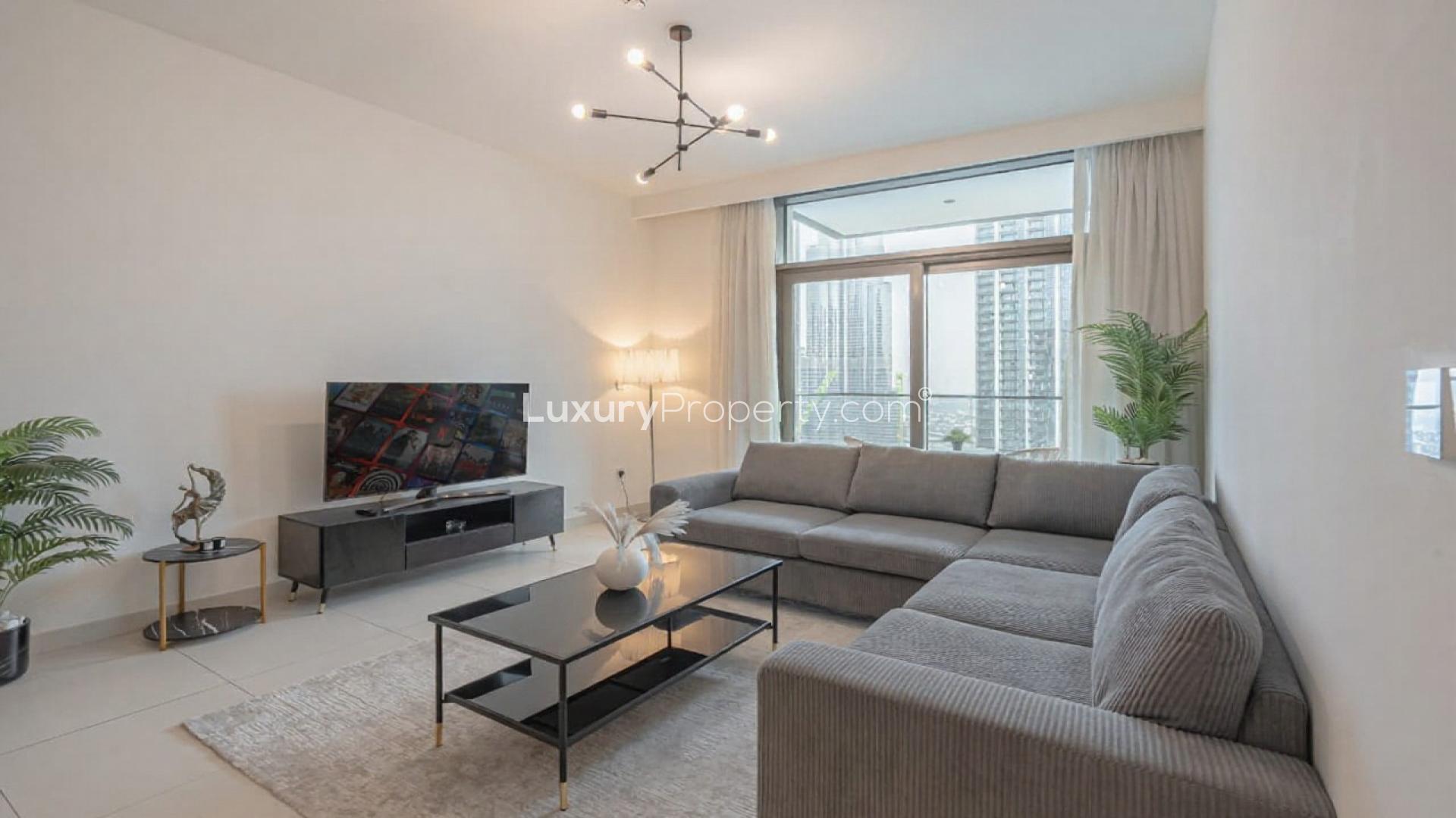 Modern living room in high-floor Burj Crown apartment, Downtown. Open kitchen and dining area