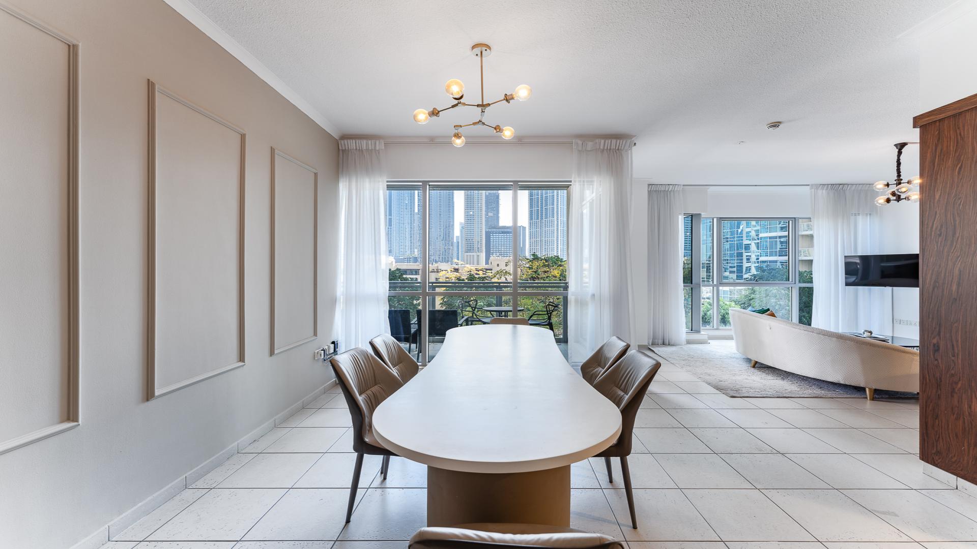 Modern dining and living area in Downtown Dubai apartment with city view