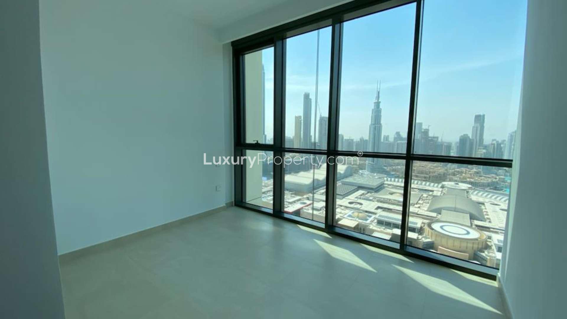 "View from 3-bedroom apartment balcony overlooking Burj Khalifa in Downtown Dubai.",Spacious apartment with Burj Khalifa view in Downtown Dubai, large windows, bright interior