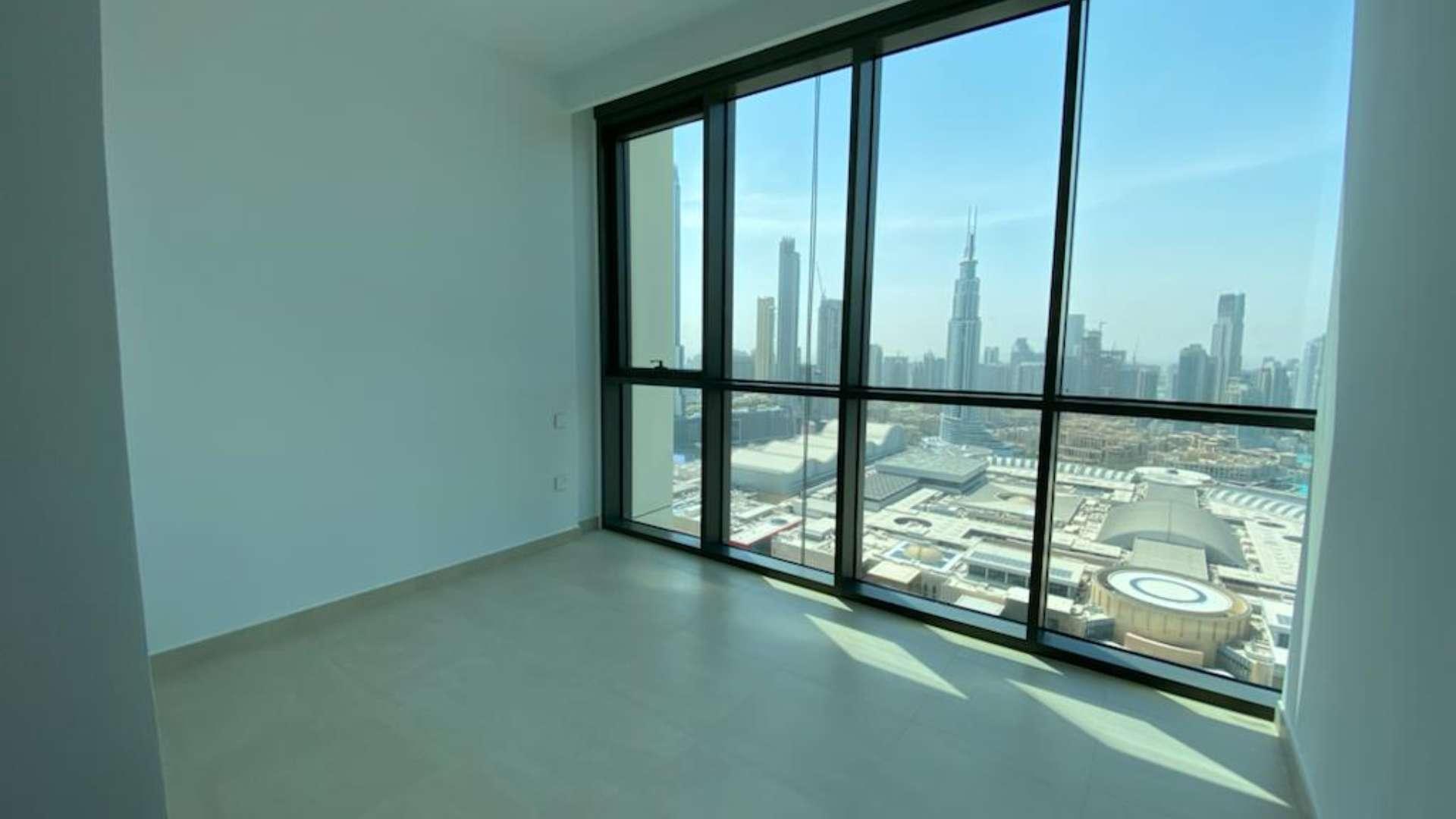 "View from 3-bedroom apartment balcony overlooking Burj Khalifa in Downtown Dubai.",Spacious apartment with Burj Khalifa view in Downtown Dubai, large windows, bright interior