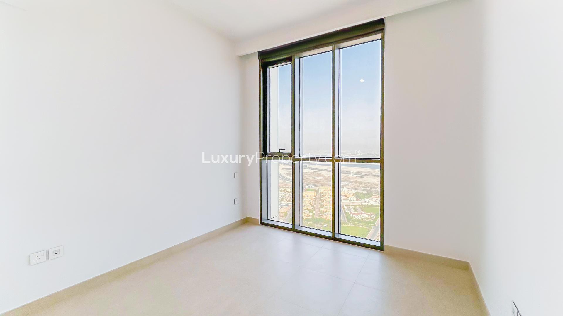 Empty room in high-floor Downtown Dubai apartment with natural light and modern finishes