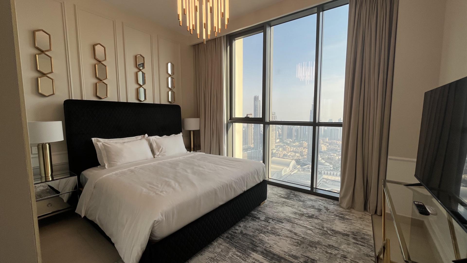 High-rise Downtown Dubai apartment bedroom with modern decor and luxurious furnishings for rent