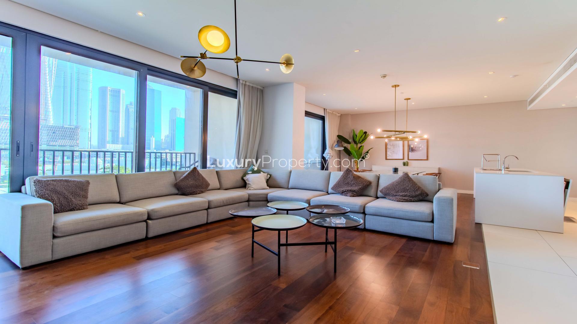 Spacious City Walk apartment interior with modern furnishings, glass table, and balcony view