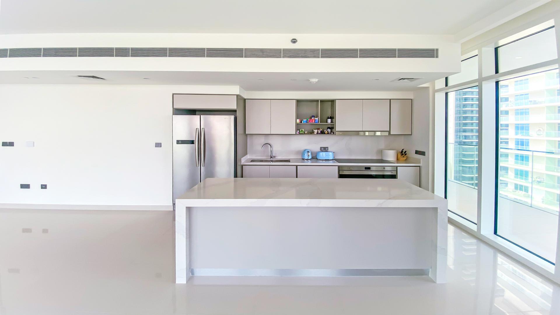 Brand new luxury beachfront apartment kitchen with panoramic Dubai Harbour view