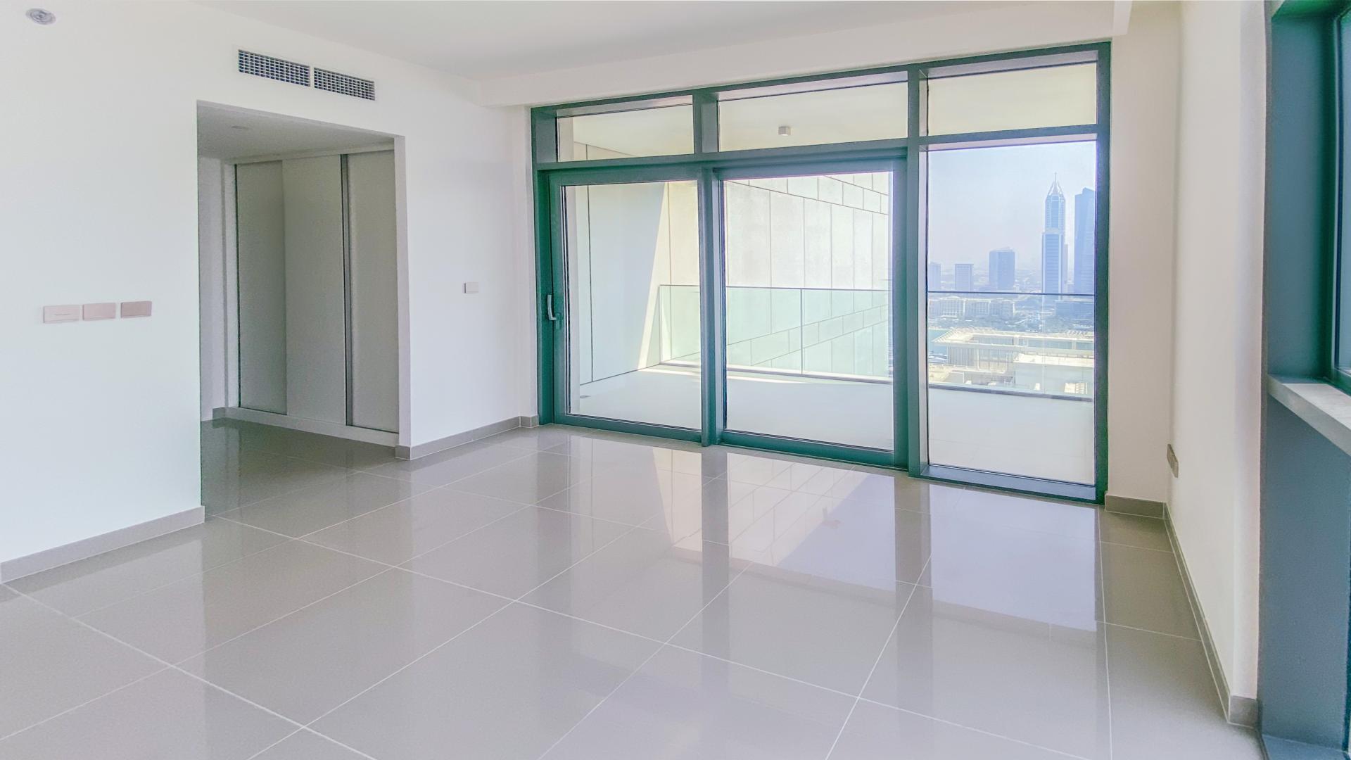 Brand new waterfront apartment interior with floor-to-ceiling windows in Emaar Beachfront, Dubai Harbour