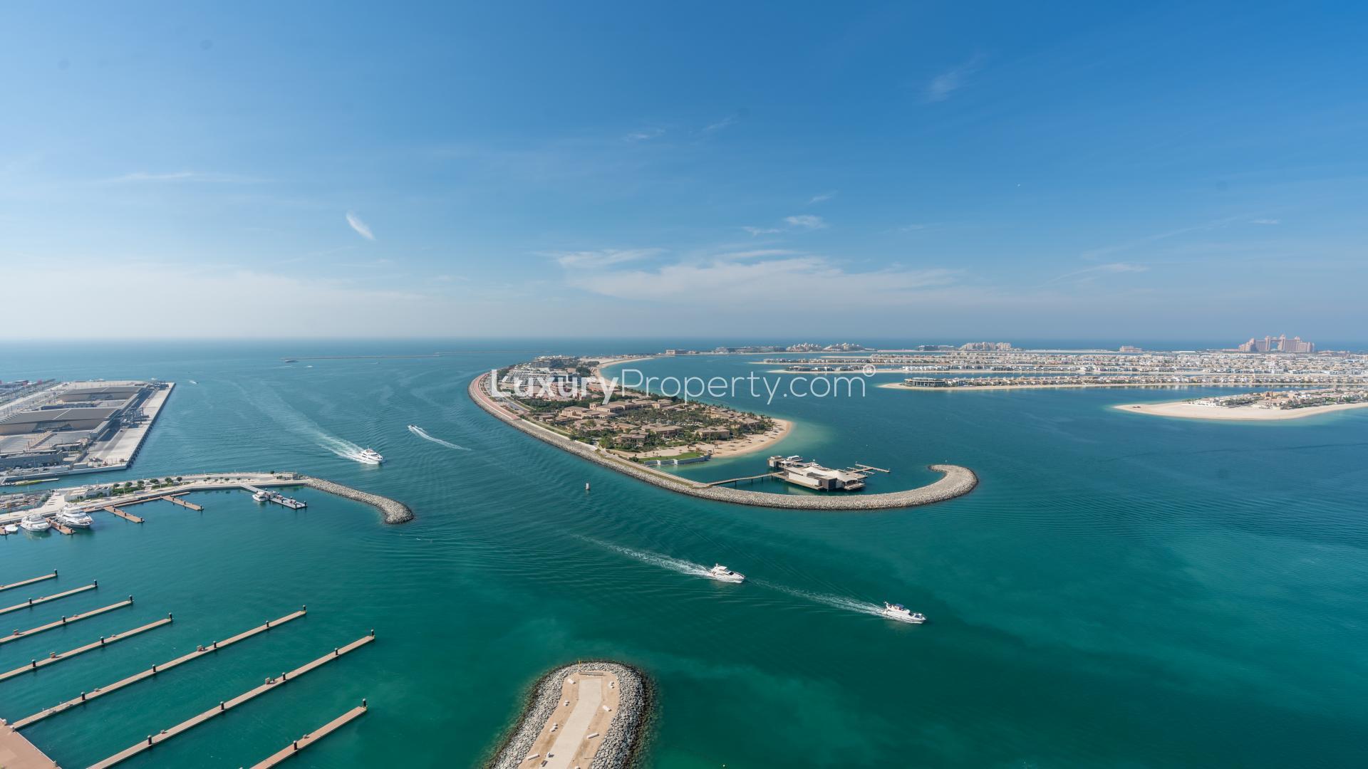 "Stunning ocean view from Beach Vista apartment balcony in Emaar Beachfront, Dubai Harbour.",Aerial view of Emaar Beachfront marina and coastline in Dubai Harbour, clear blue skies