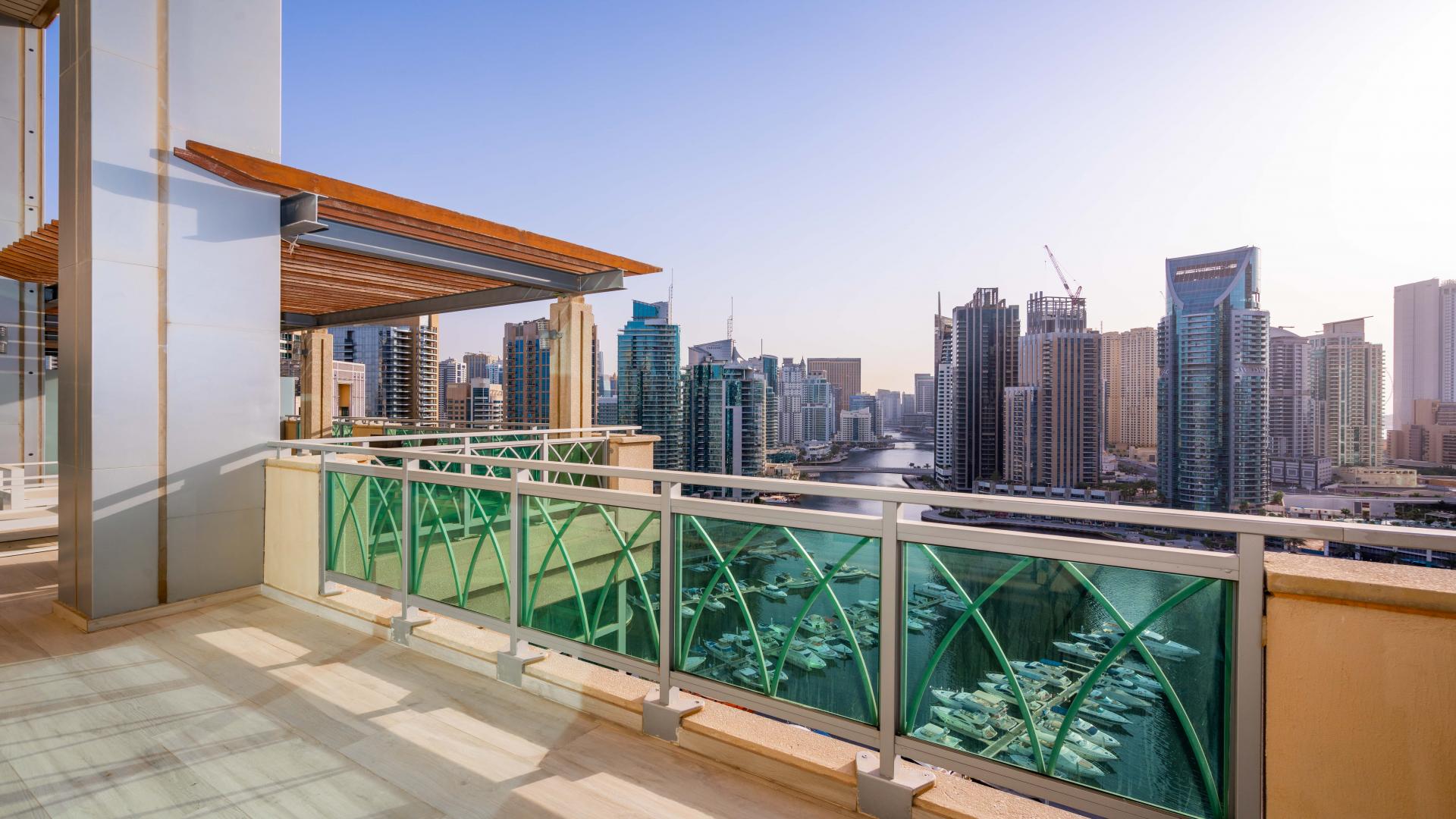 Dubai Marina view with Emaar 6 Towers and yachts, highlighting luxury apartment location