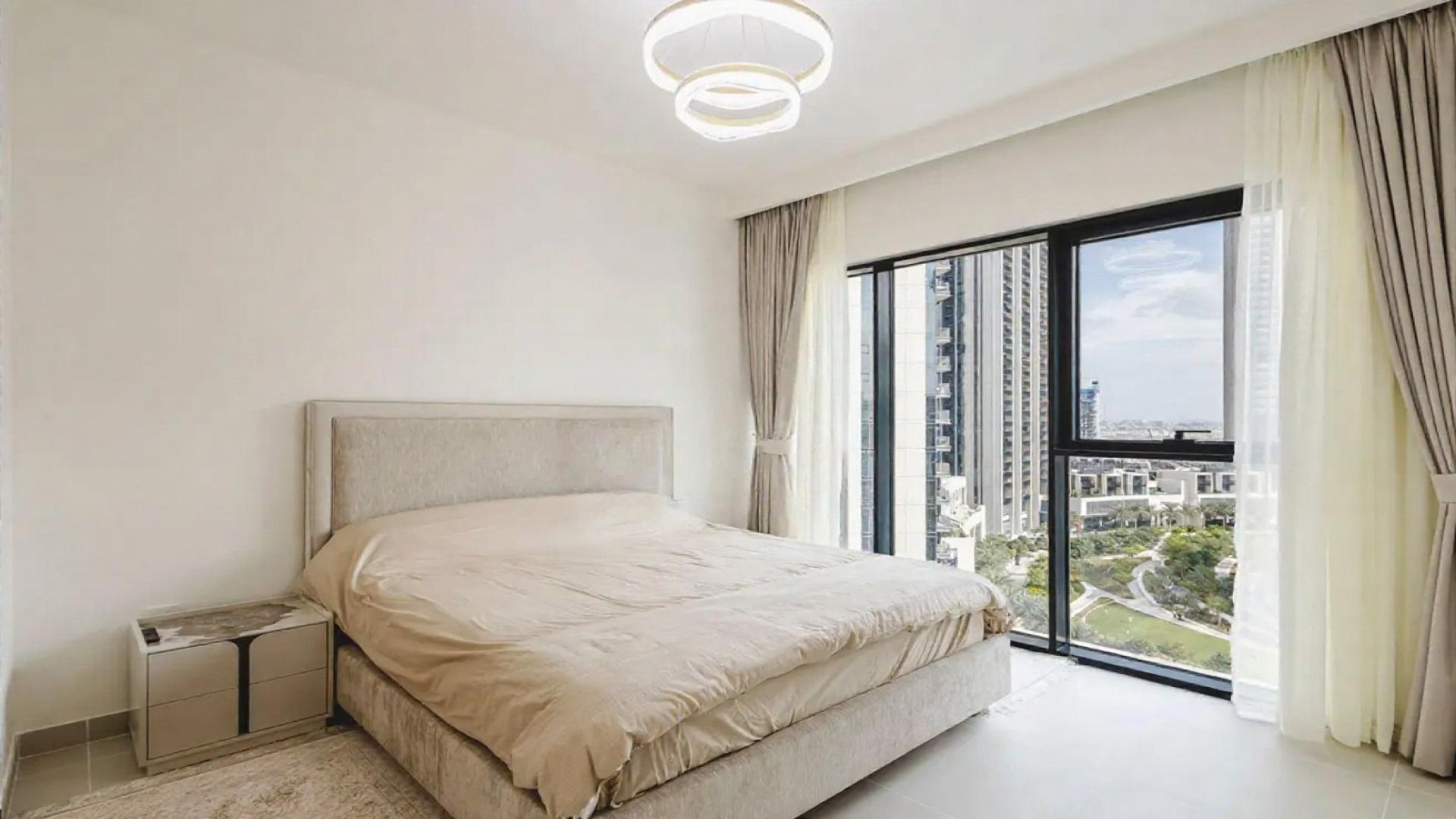 Modern kitchen in Dubai Creek Harbour apartment, featuring sleek cabinets and dining area