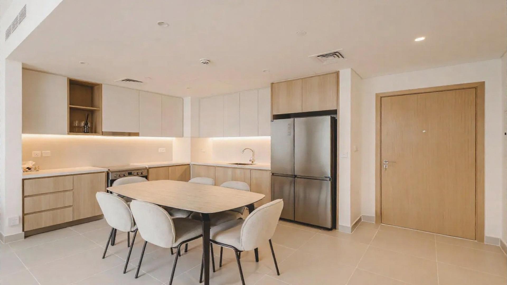 Spacious living room with modern kitchen in Dubai Creek Harbour apartment for rent