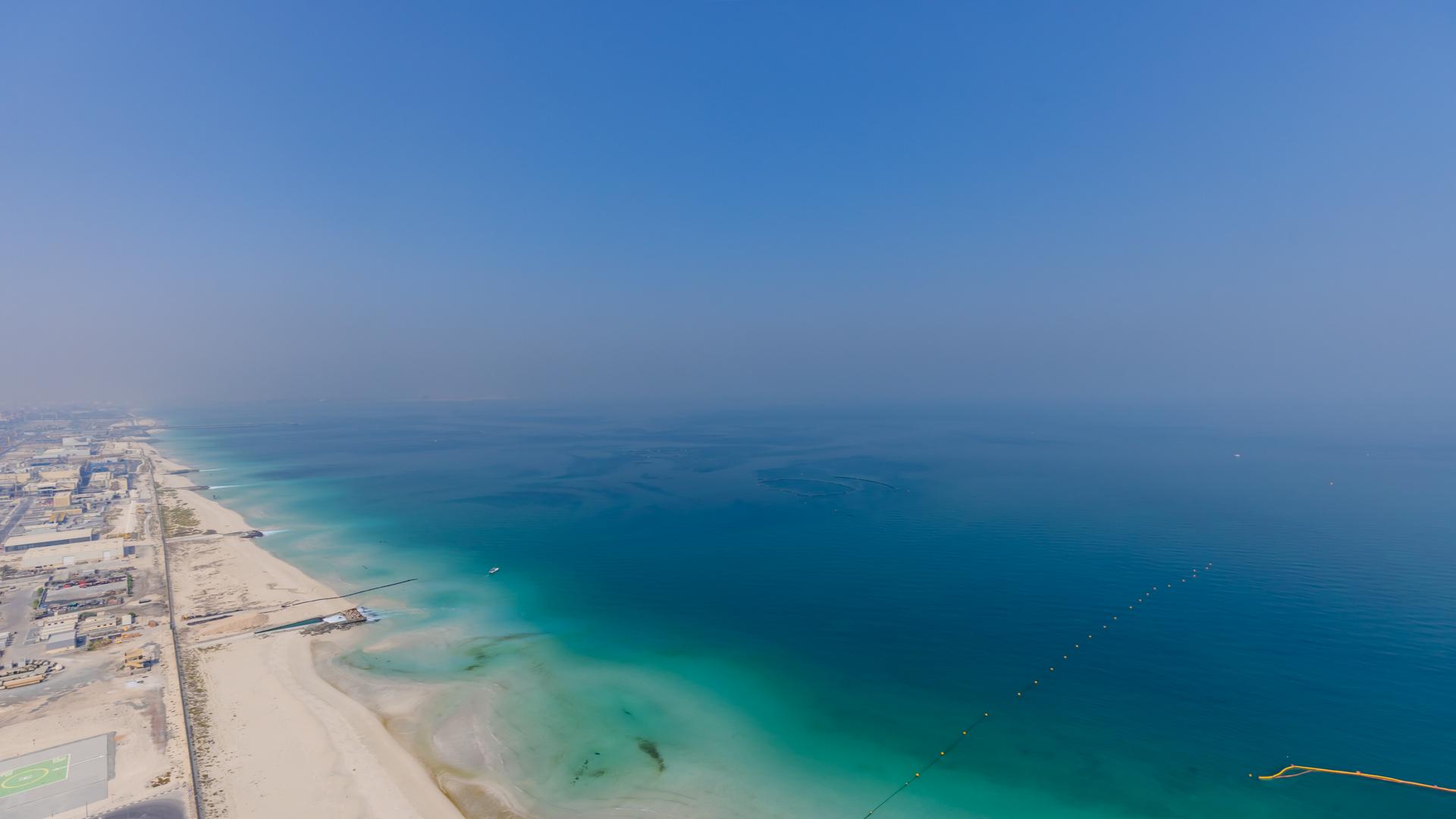 "Spacious balcony with stunning sea views in Dubai Marina apartment for rent.",Aerial view of Dubai Marina beachfront near luxury apartment in 5242 community